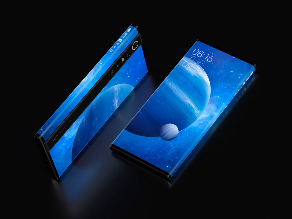 Two Mi Mix Alpha phones, one facing up and one on its side, showing the black strip that houses its camera.