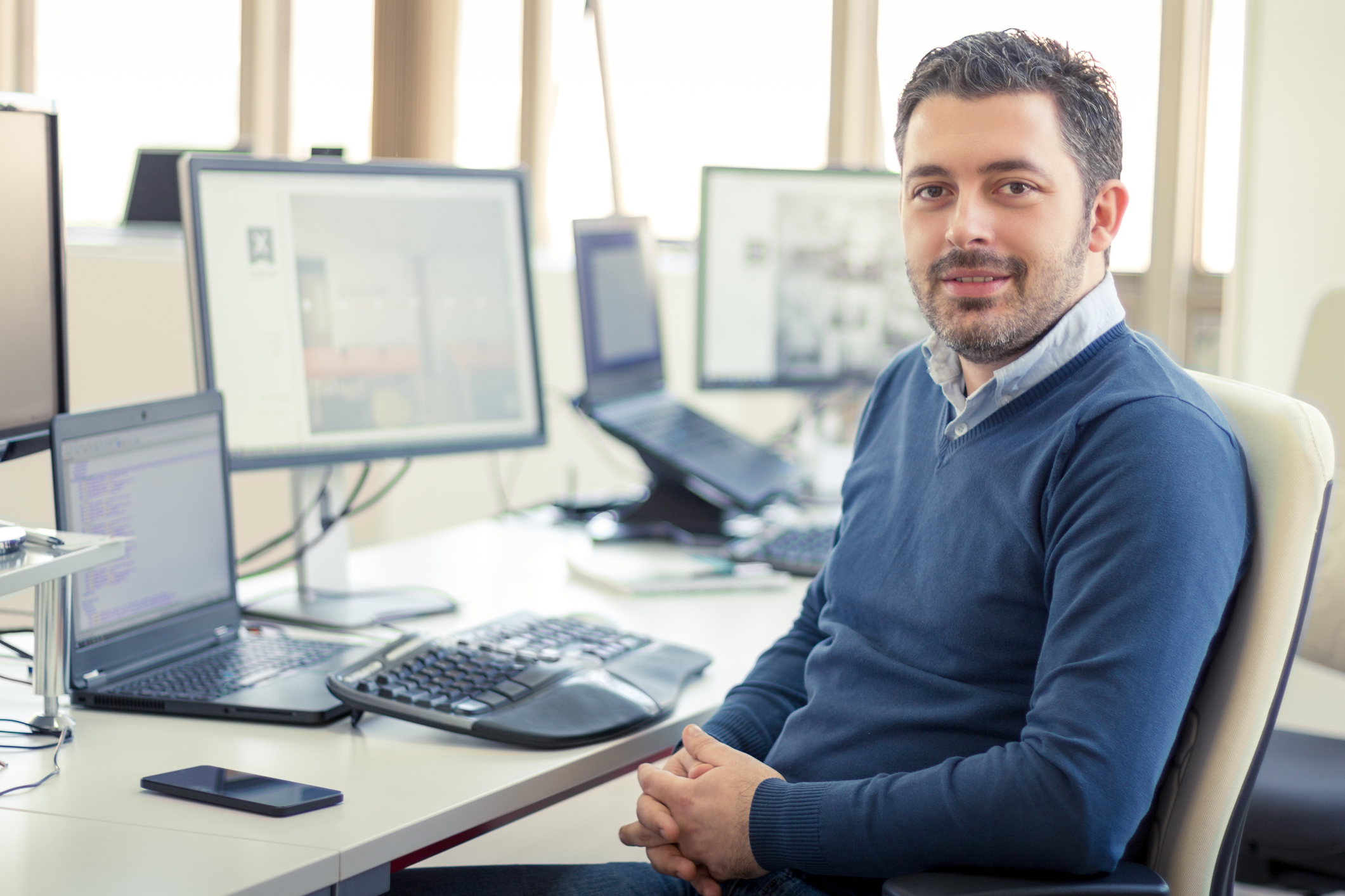 Smiling man at an office desk