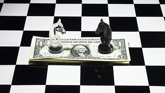 Black vs white chess knights on a dolla bill
