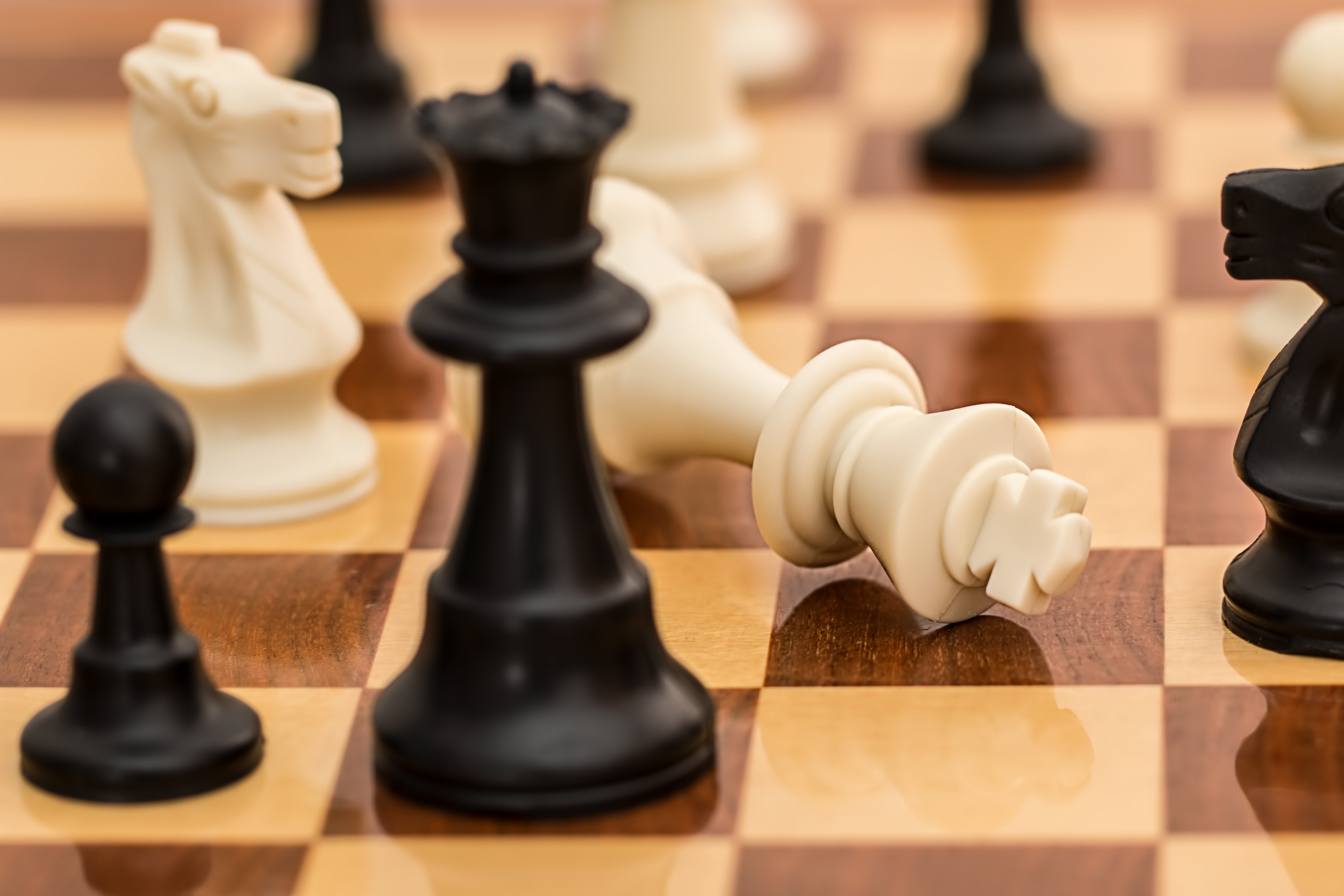 chessboard with the king knocked over in checkmate
