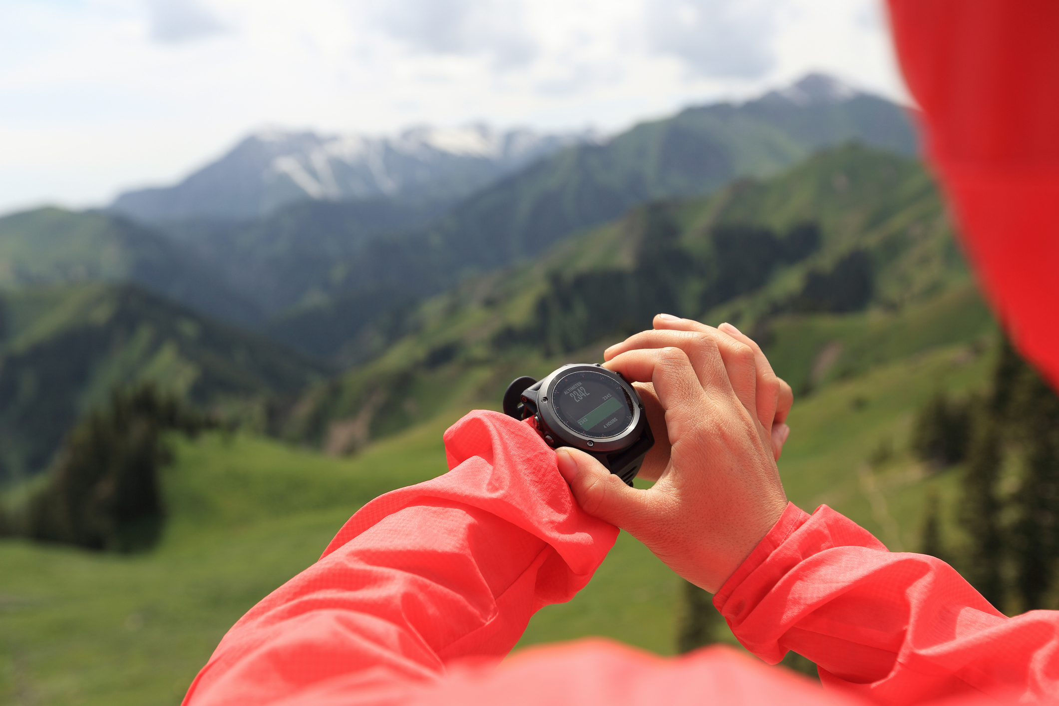 A hiker interacts with her smartwatch.