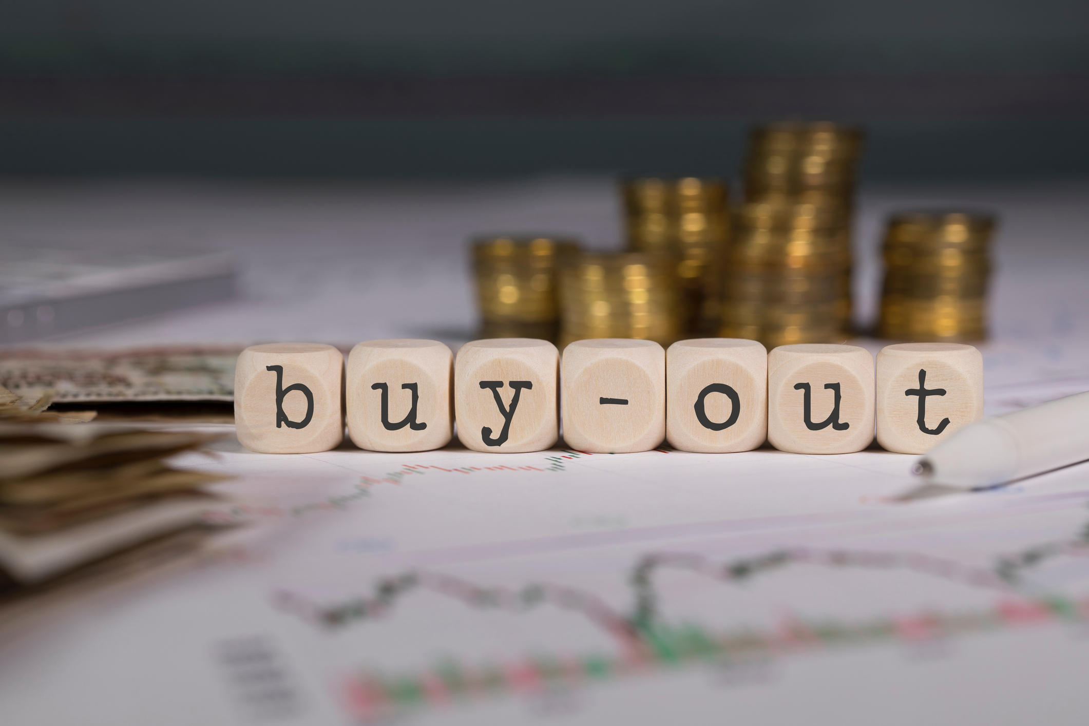 Wooden blocks that spell out "buy-out".