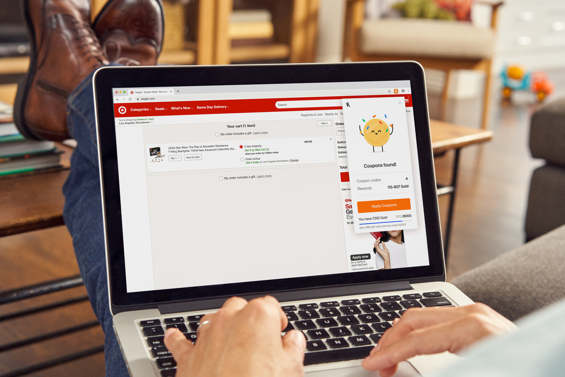 A man shopping on a laptop displaying the Honey browser plug-in showing Coupons Found.