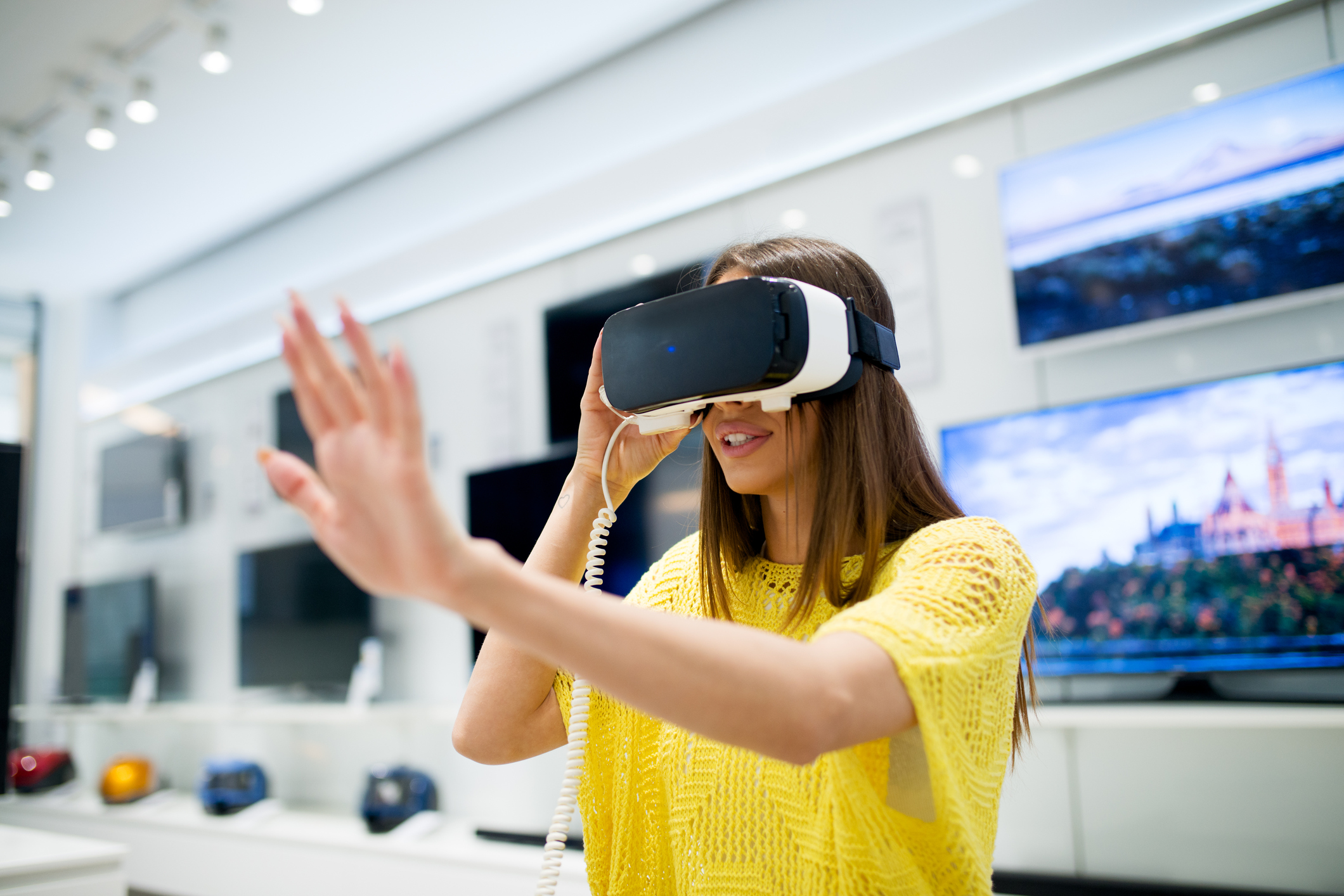A woman tries on a VR headset.