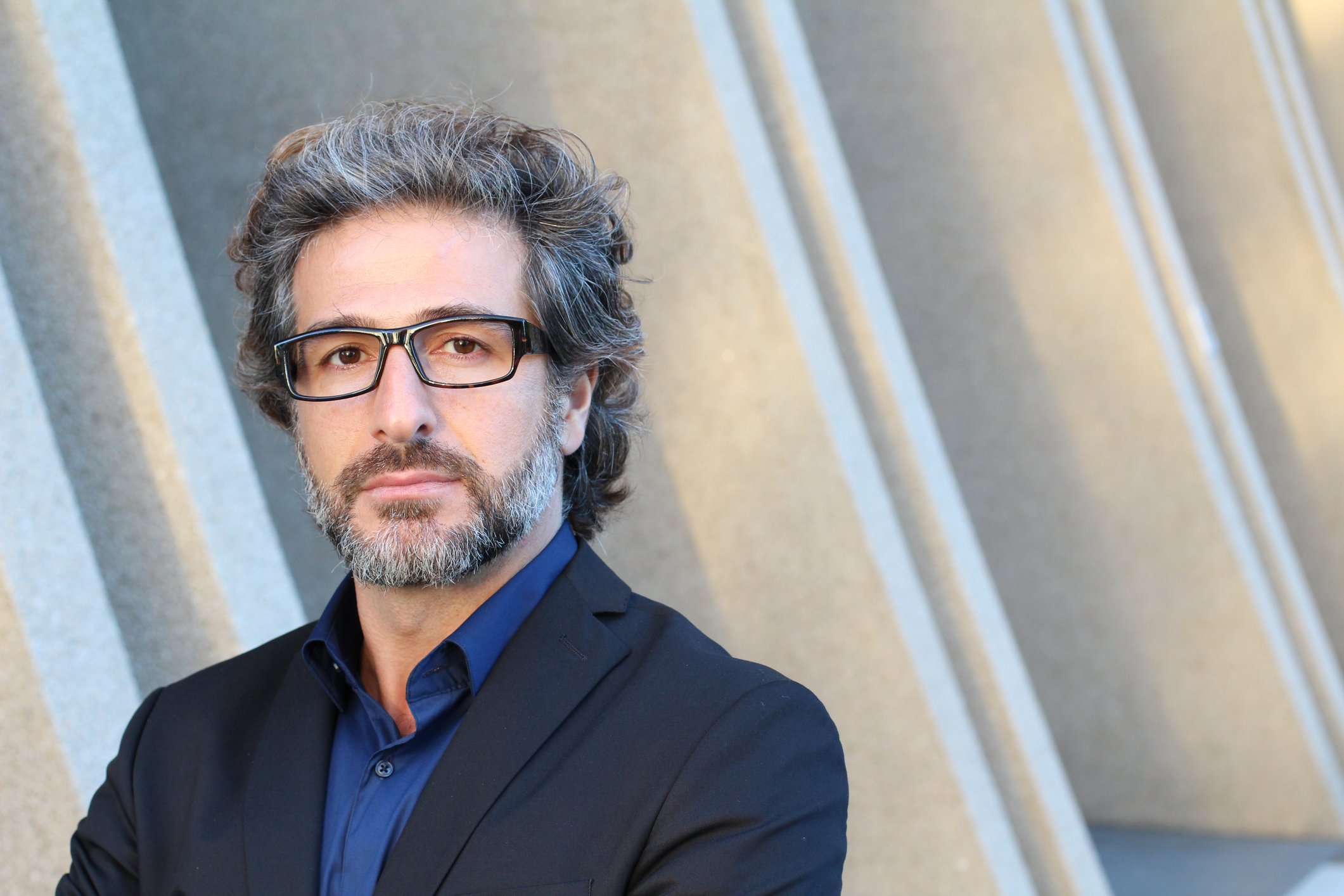 Middle-aged man wearing glasses with serious expression