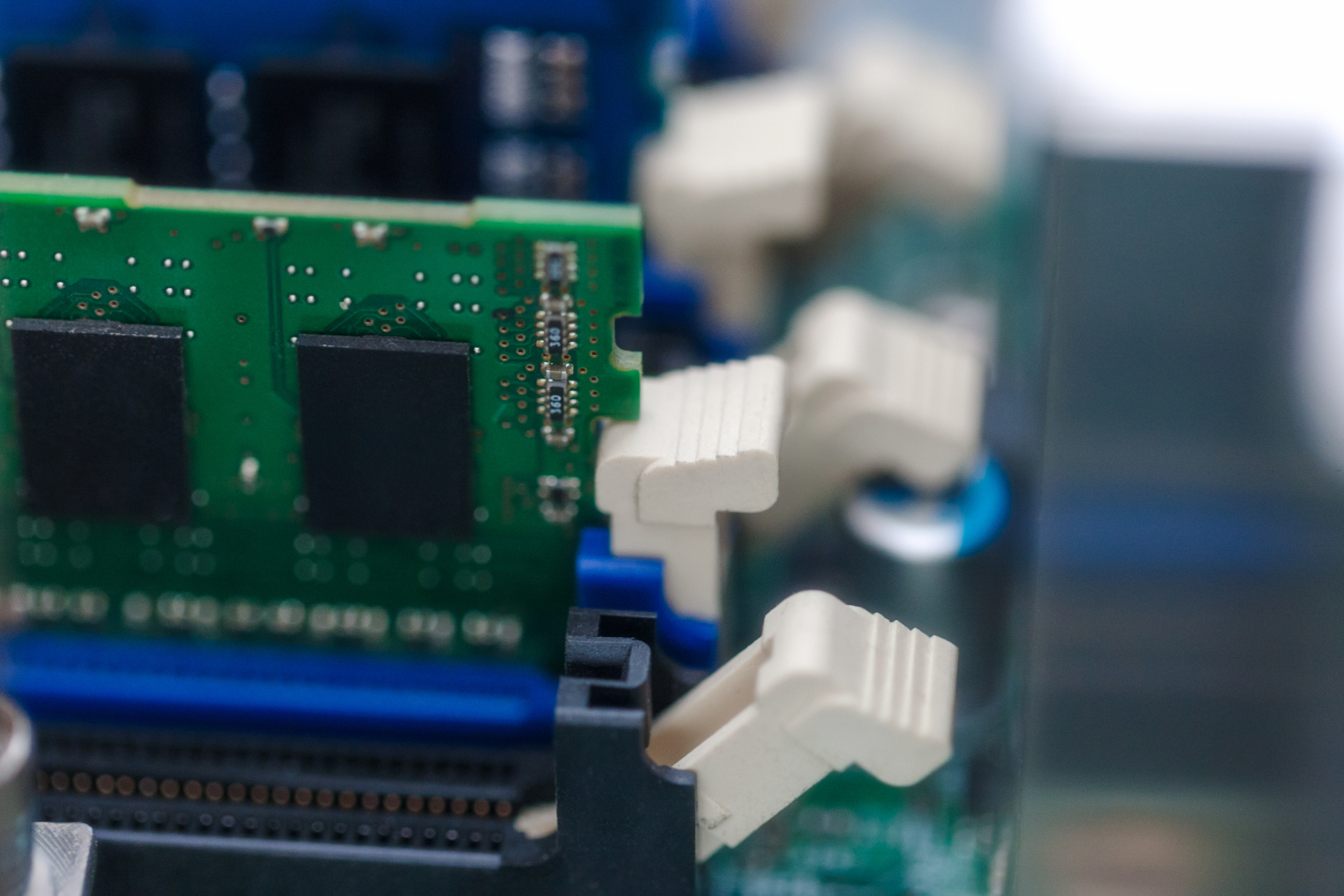 A close-up of DRAM chips on a motherboard.