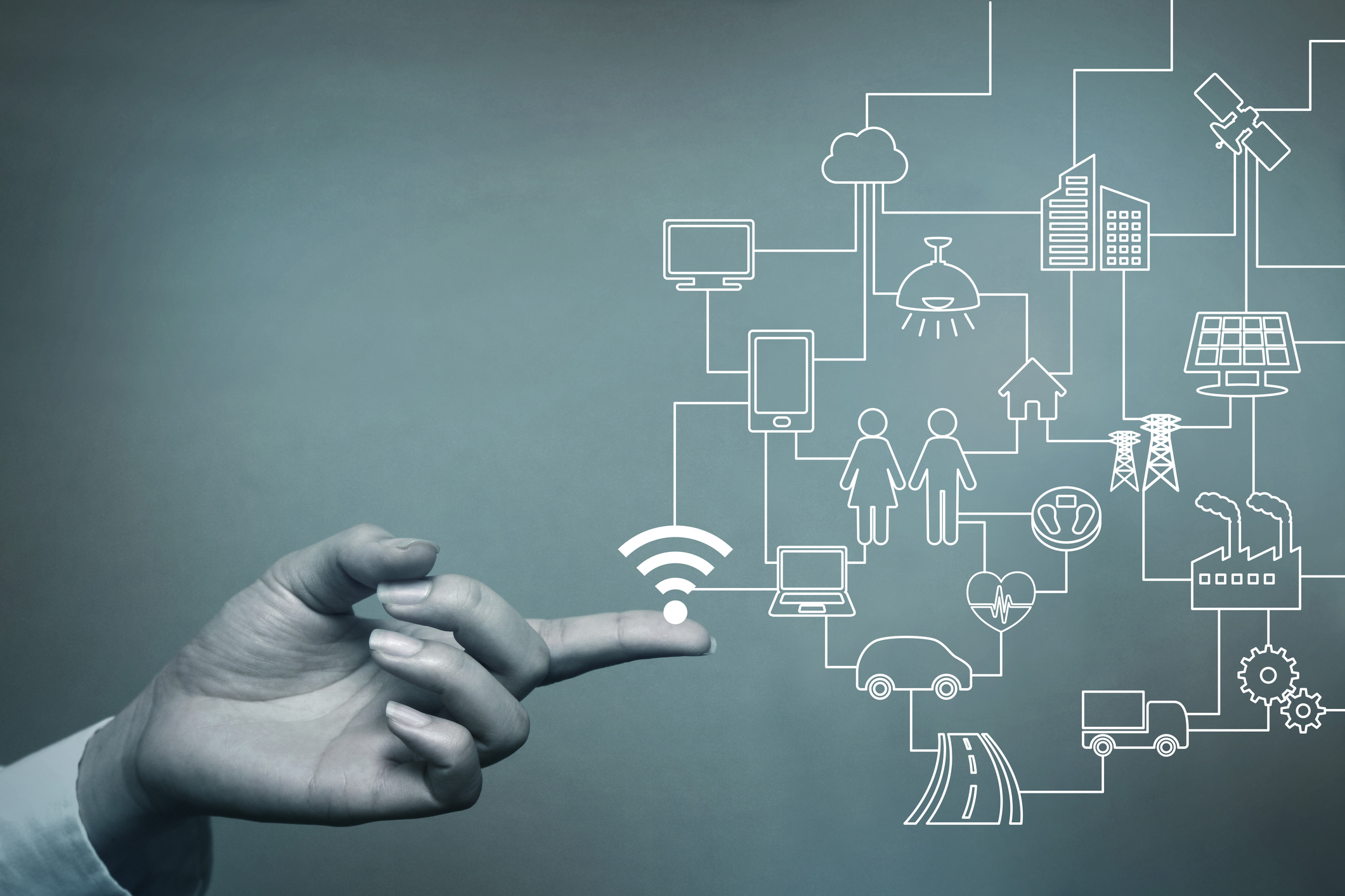 A network of connected things sprouts out of a man's finger.