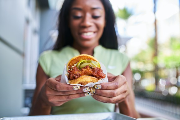 Woman holding a crispy fried chicken sandwich