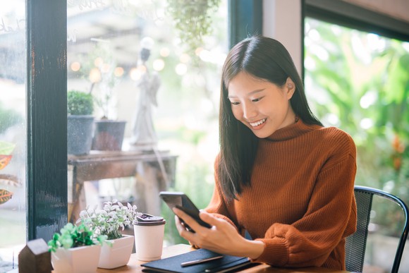 Woman looking at her phone and smiling