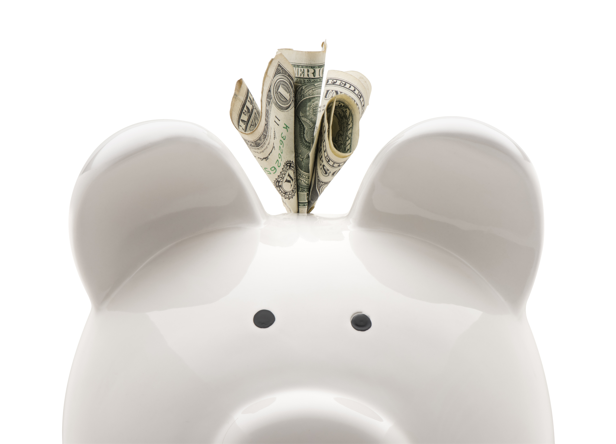 White piggy bank with dollar bill sticking out of it