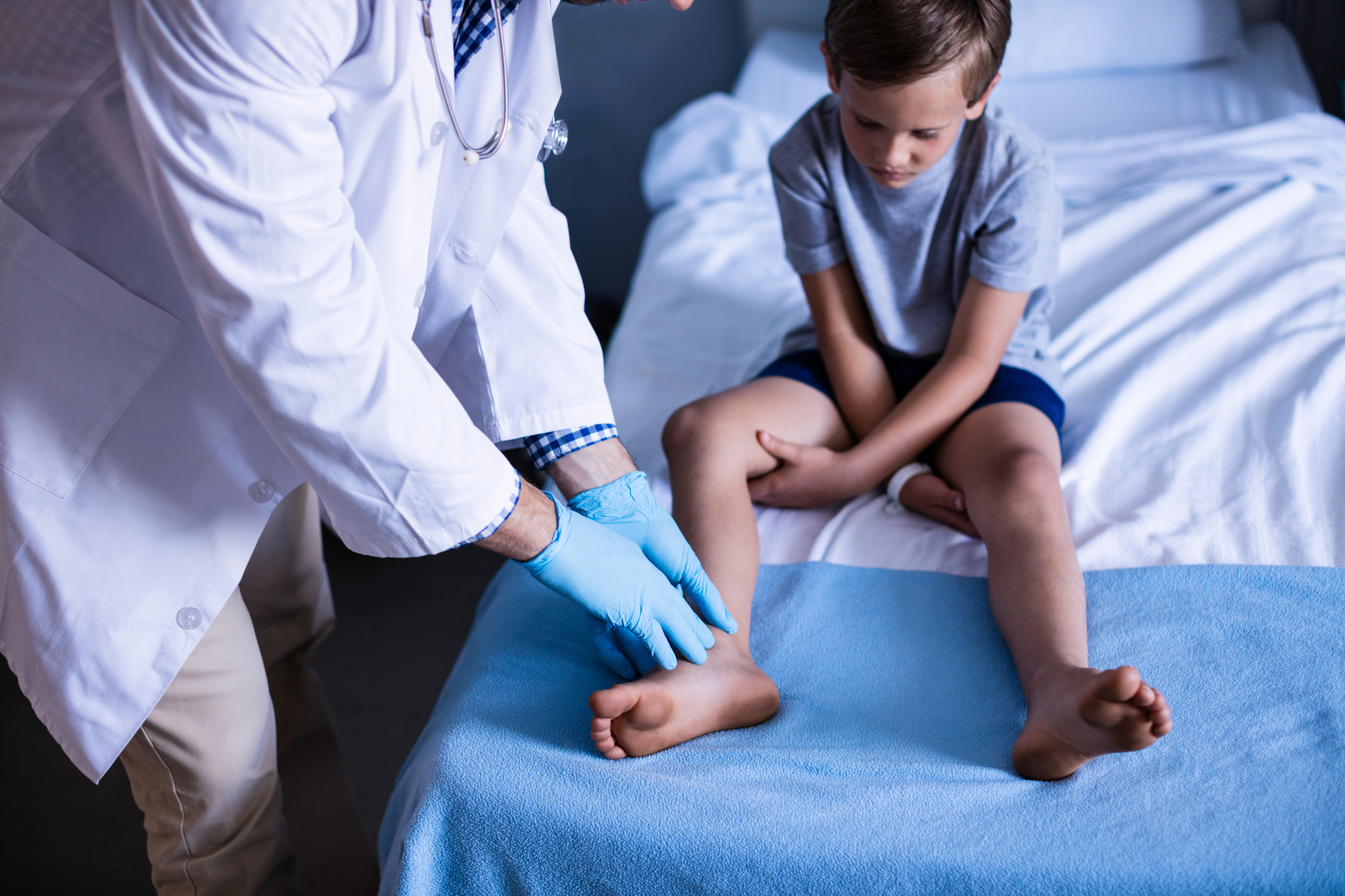 Doctor examining a boy's leg