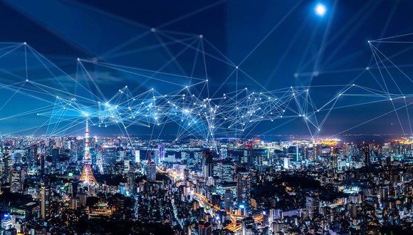Connected lines appear over a cityscape at night, suggesting a web of connected digital networks.