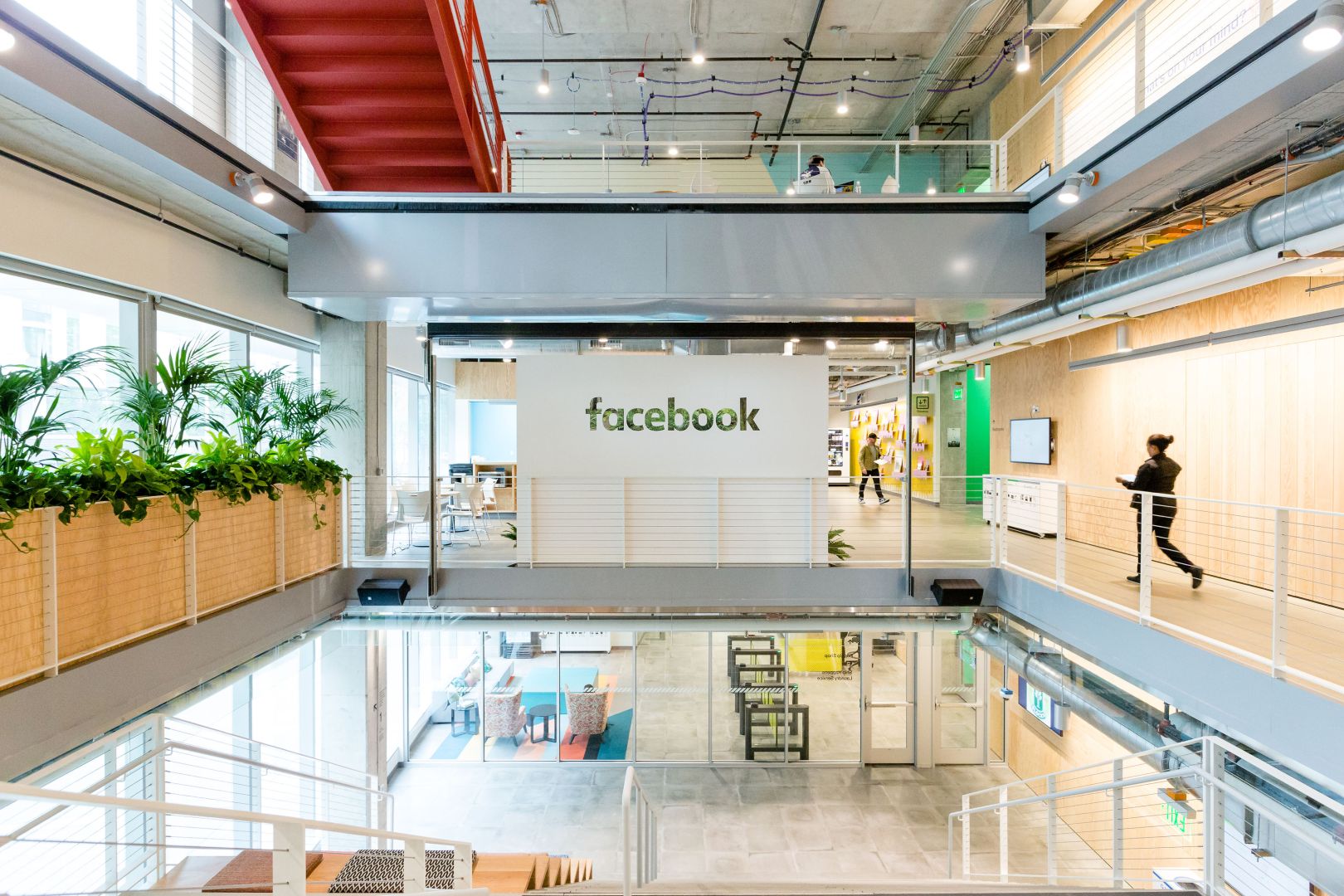 A person walks near a Facebook logo in the company's Seattle offices.