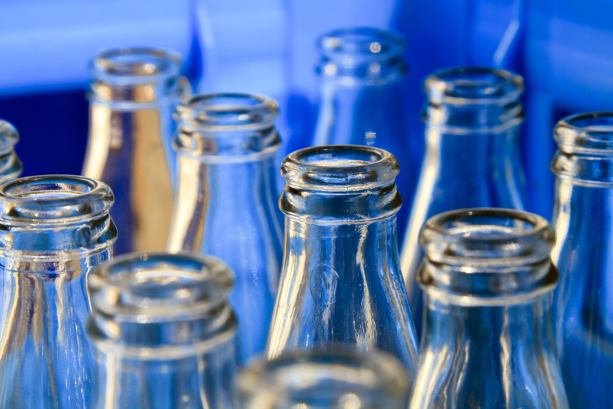 Close-up of empty soda bottles in a bottling plant.