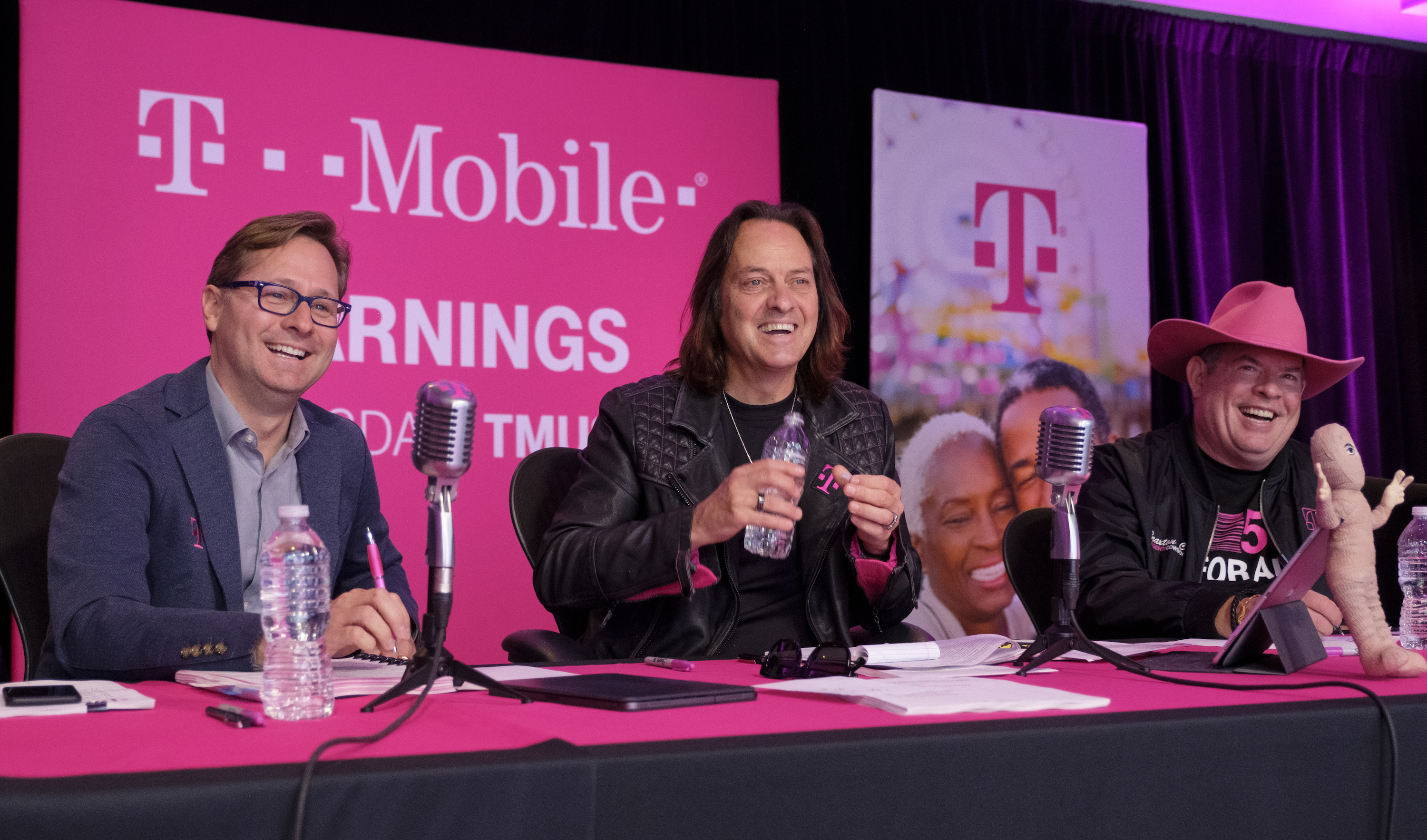 T-Mobile executives sitting behind a table with microphones on the Q3 2019 earnings call