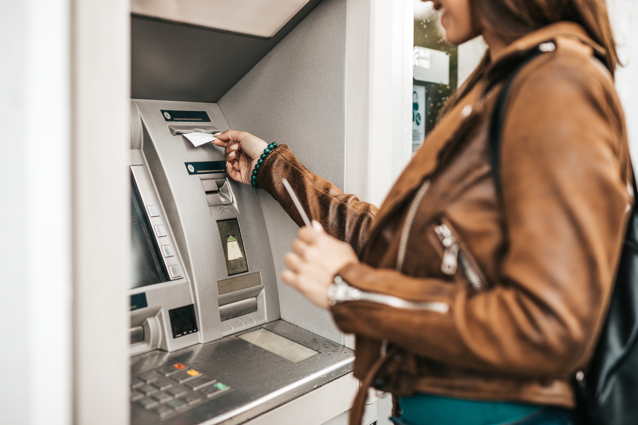 A woman using an ATM.