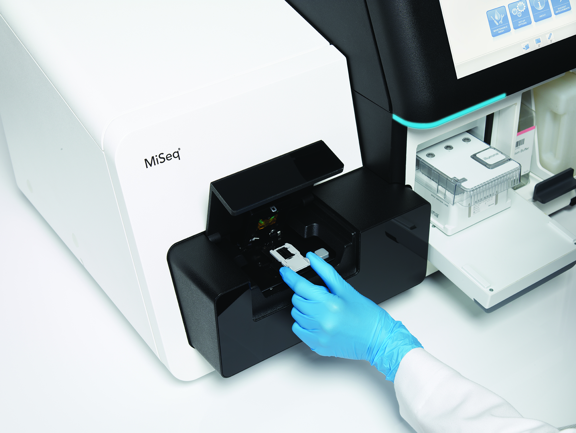 Scientist placing sample in an Illumina MiSeq