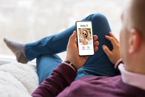 Man looking at picture of woman on mobile phone