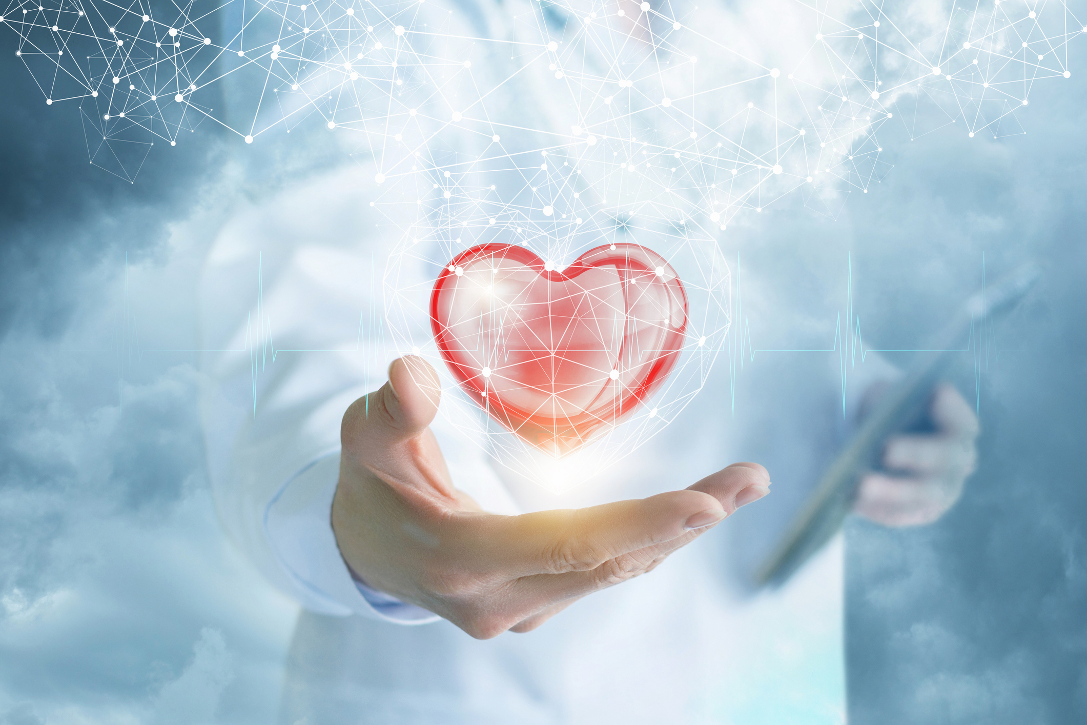 Abstract picture of a doctor with a heart floating above his or her hand.