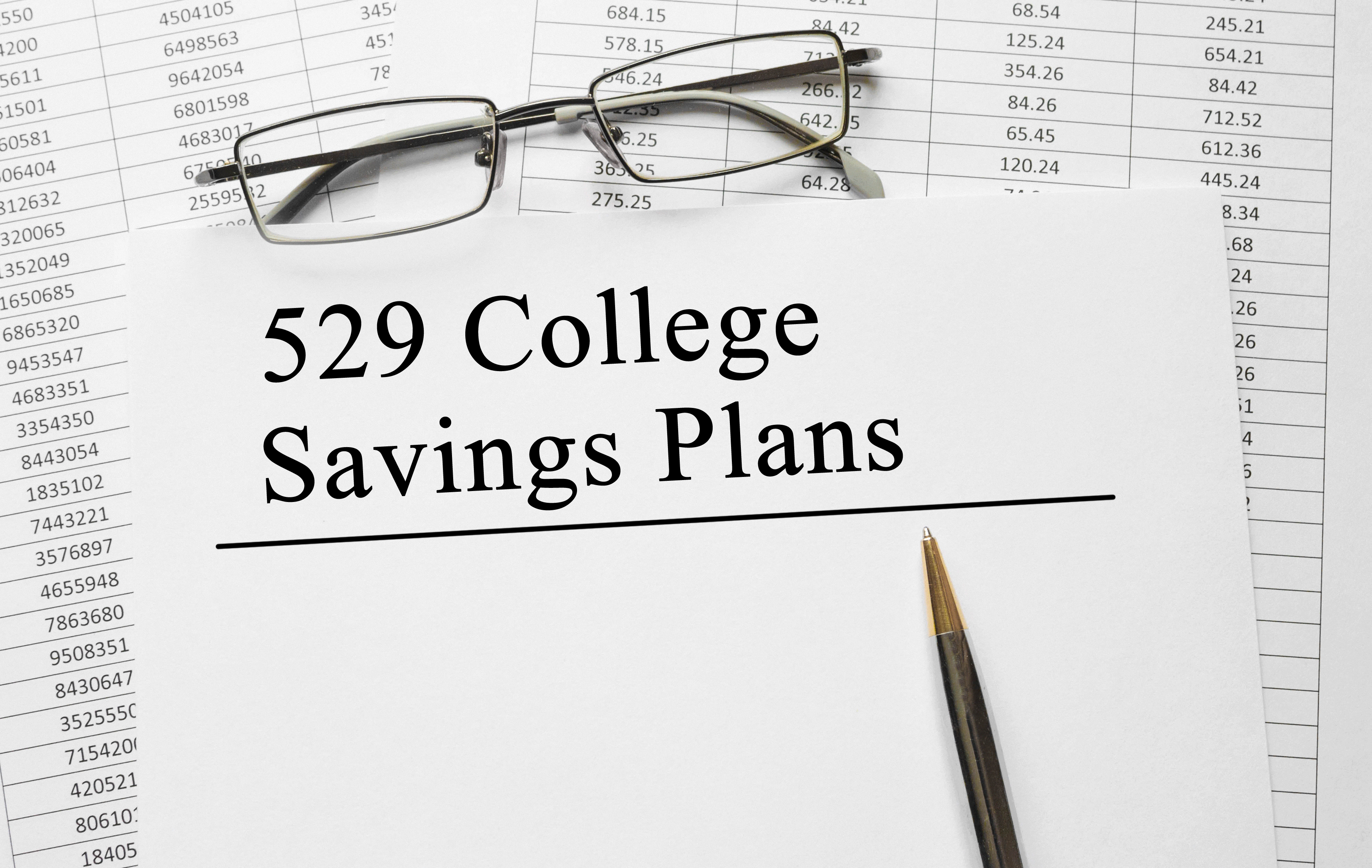 Cover of 529 savings plan with pen resting on it