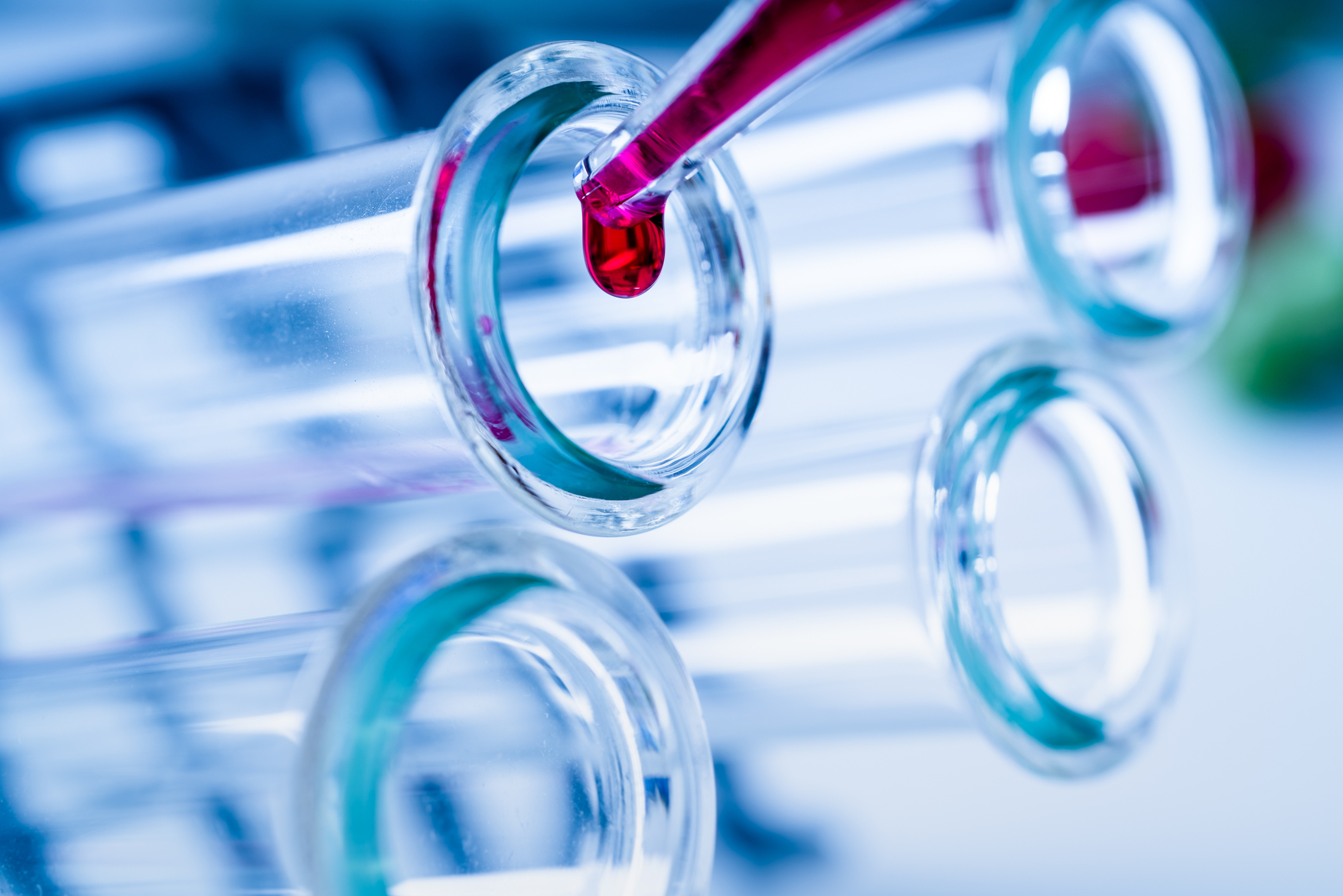 Pipette dropping blood into one of several test tubes