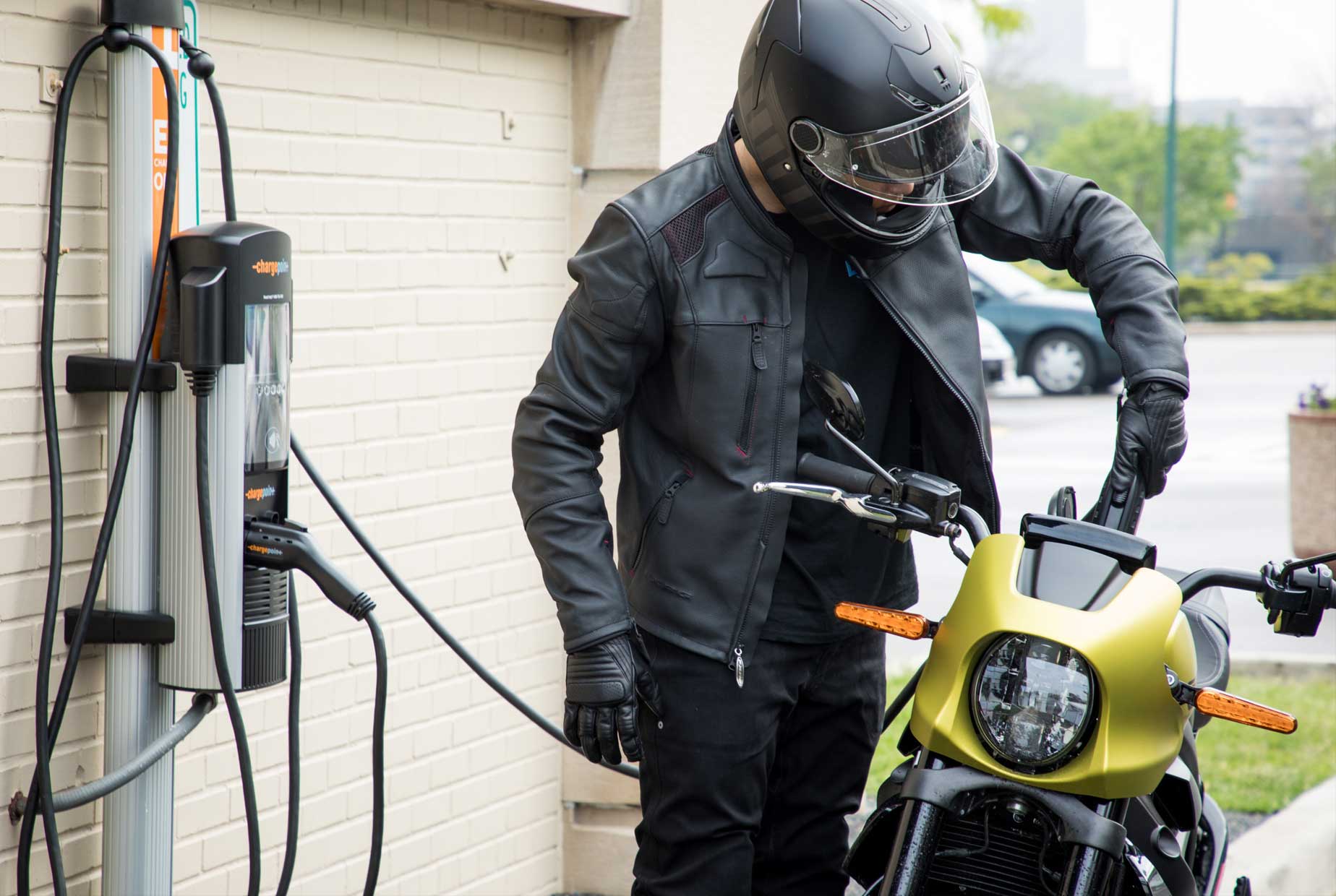Motorcyclist using a fast charge charging station for the LiveWire