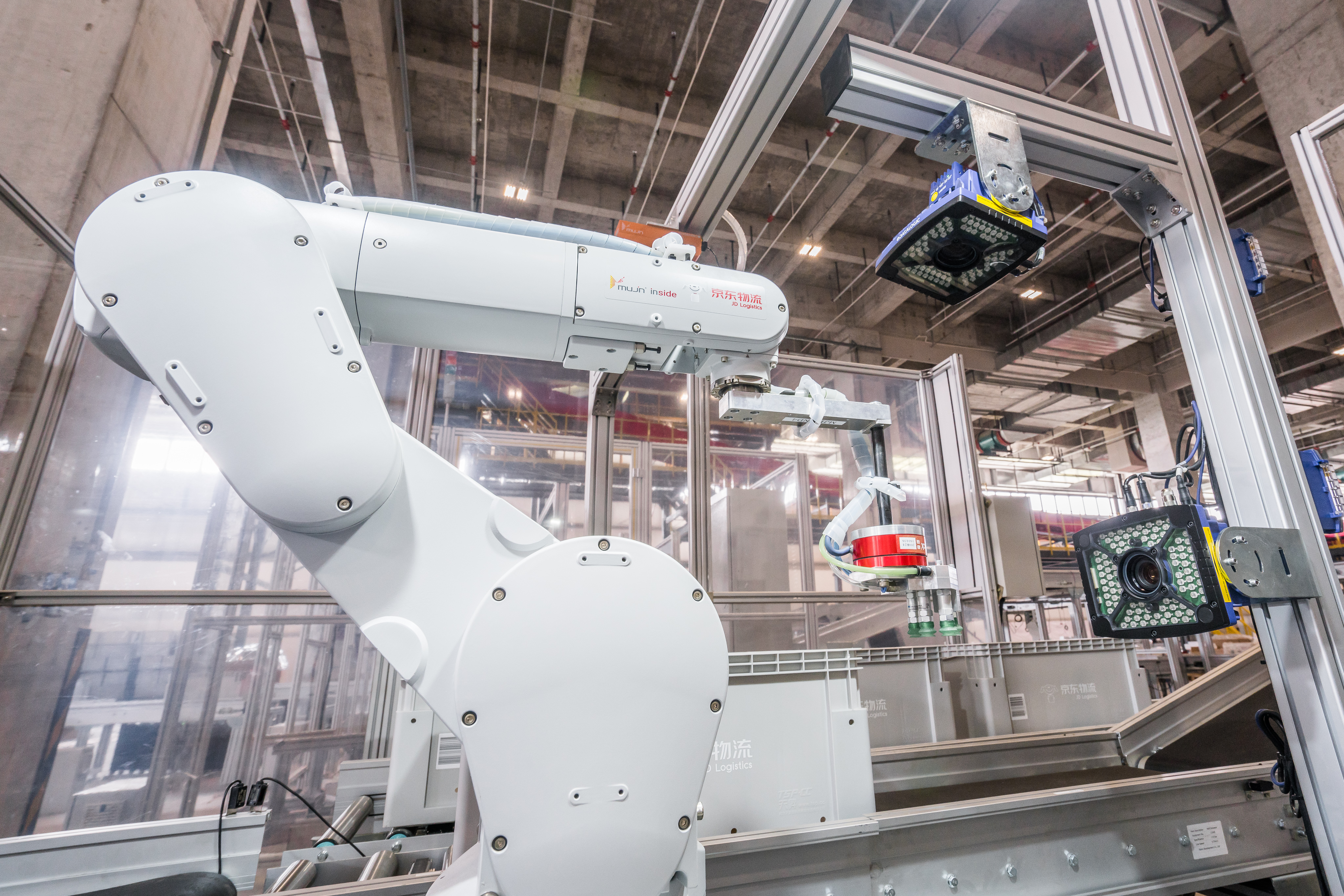 A large robot arm picks items for packing at a JD.com warehouse in Shanghai.