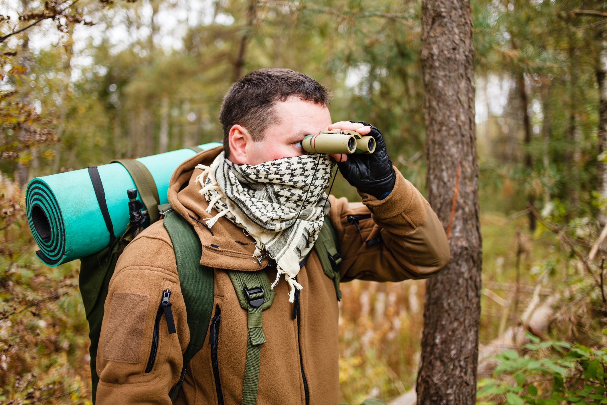 Hiker with binoculars in the woods