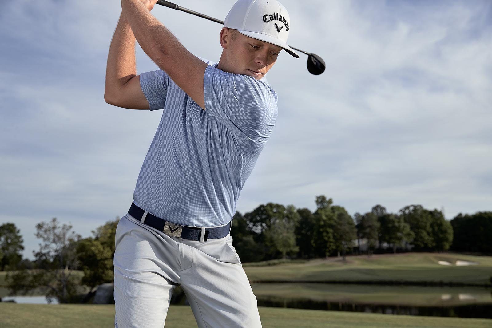 a golfer is shown in mid-swing while wearing Callaway Golf apparel