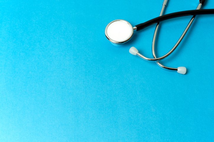 A stethoscope on a blue surface.