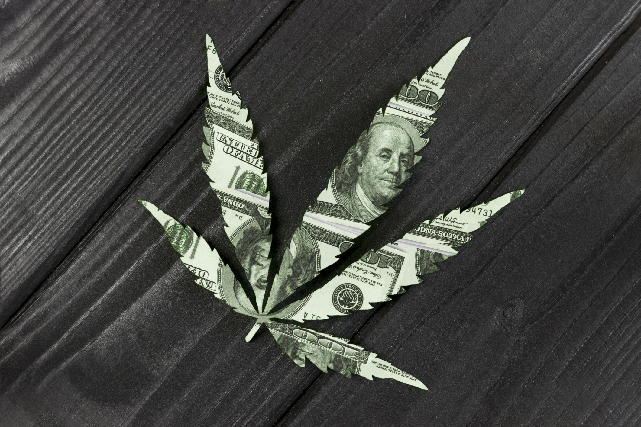 US currency in the shape of a marijuana leaf.