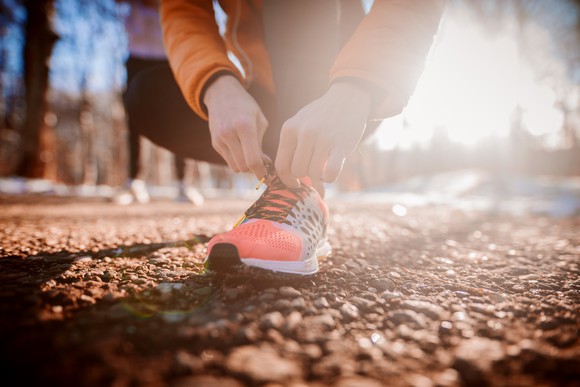 Man Tying Laces on Running Shoe