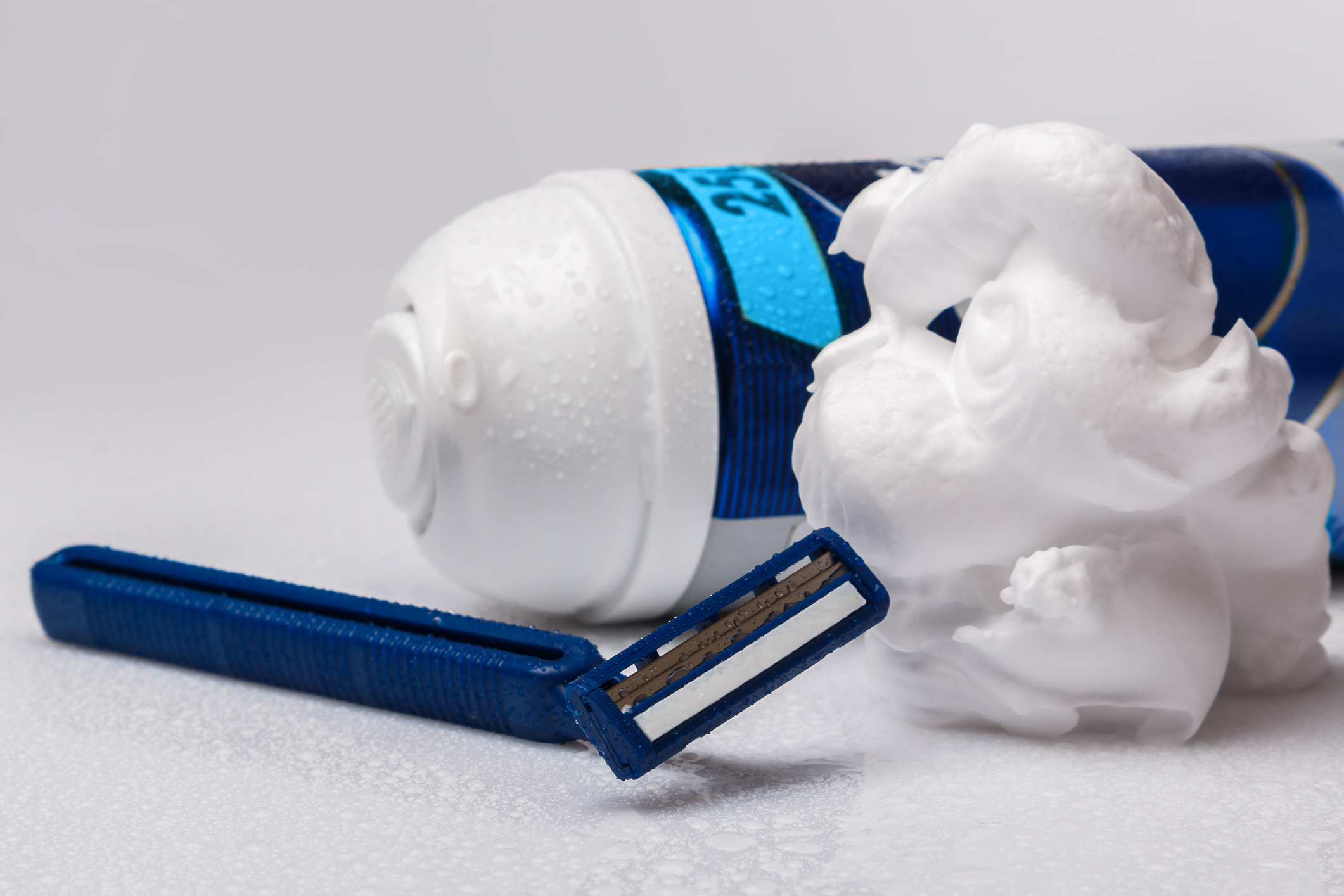 Some shaving cream, a cannister and a razor.