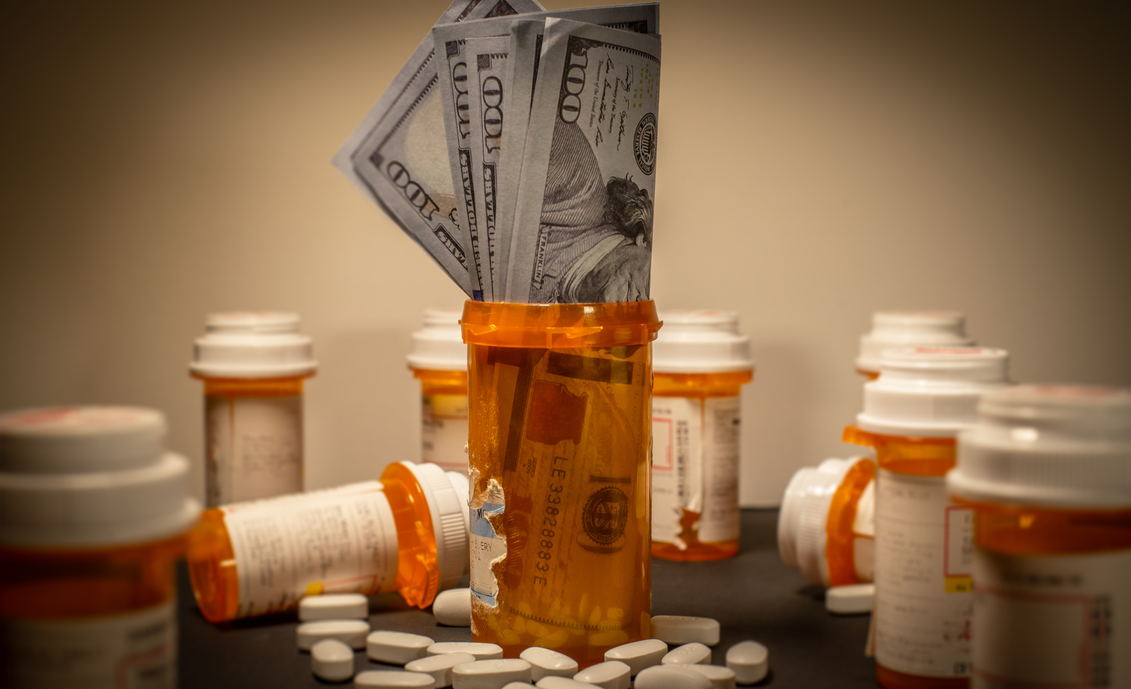 Hundred dollar bills stuffed into a prescription drug bottle.