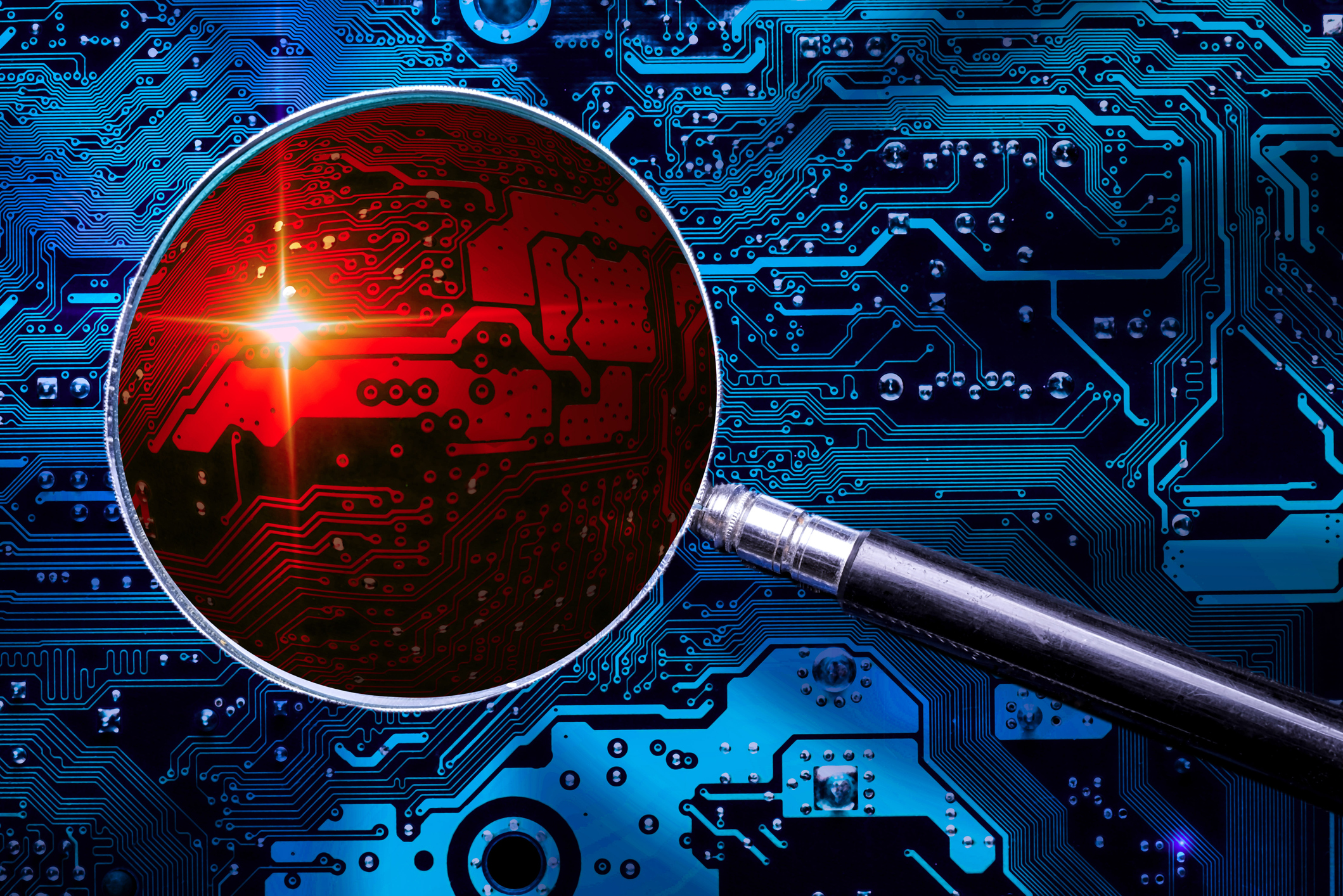 A magnifying glass on a circuit board