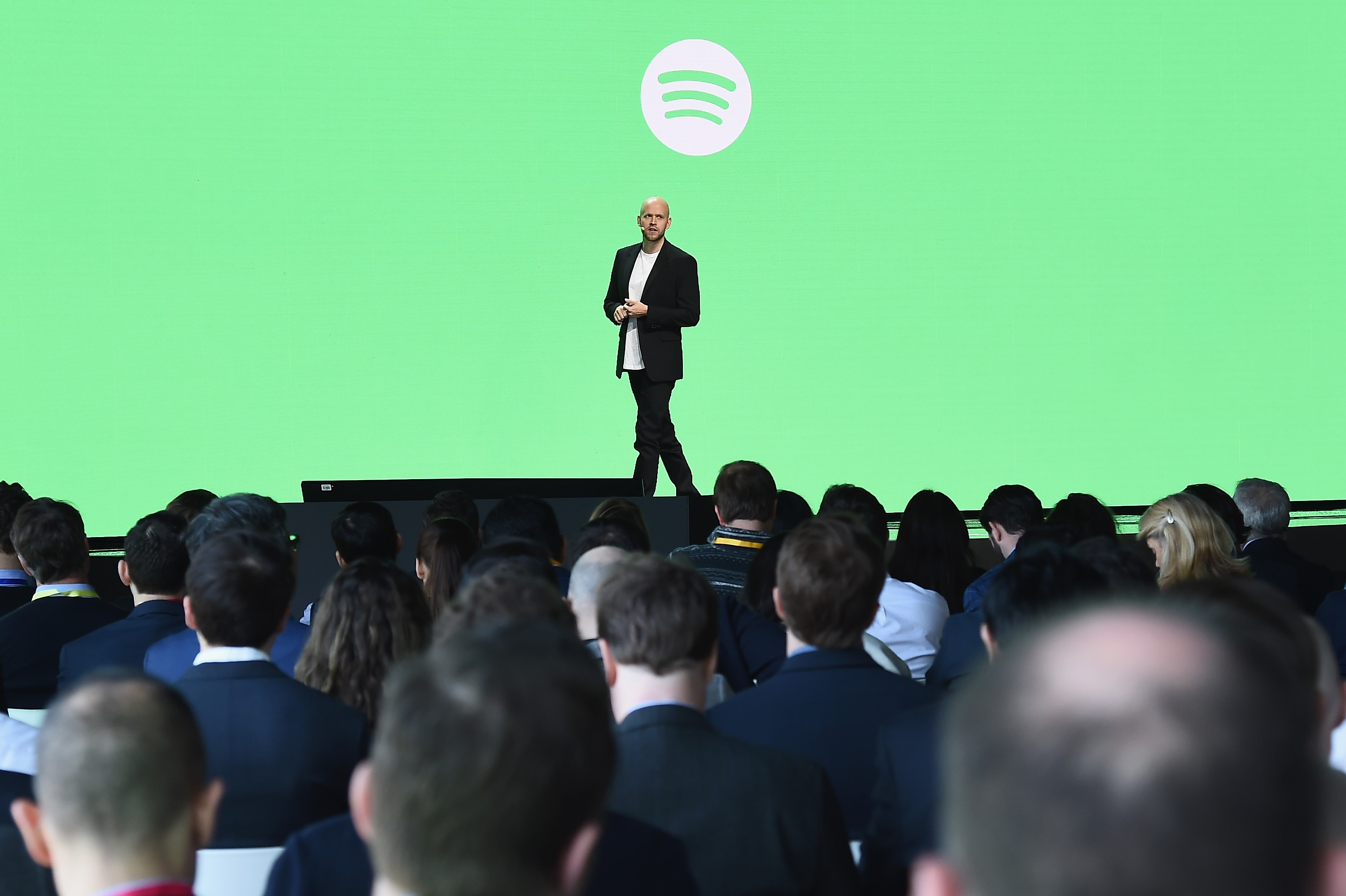 Daniel Ek on stage in front of the Spotify logo