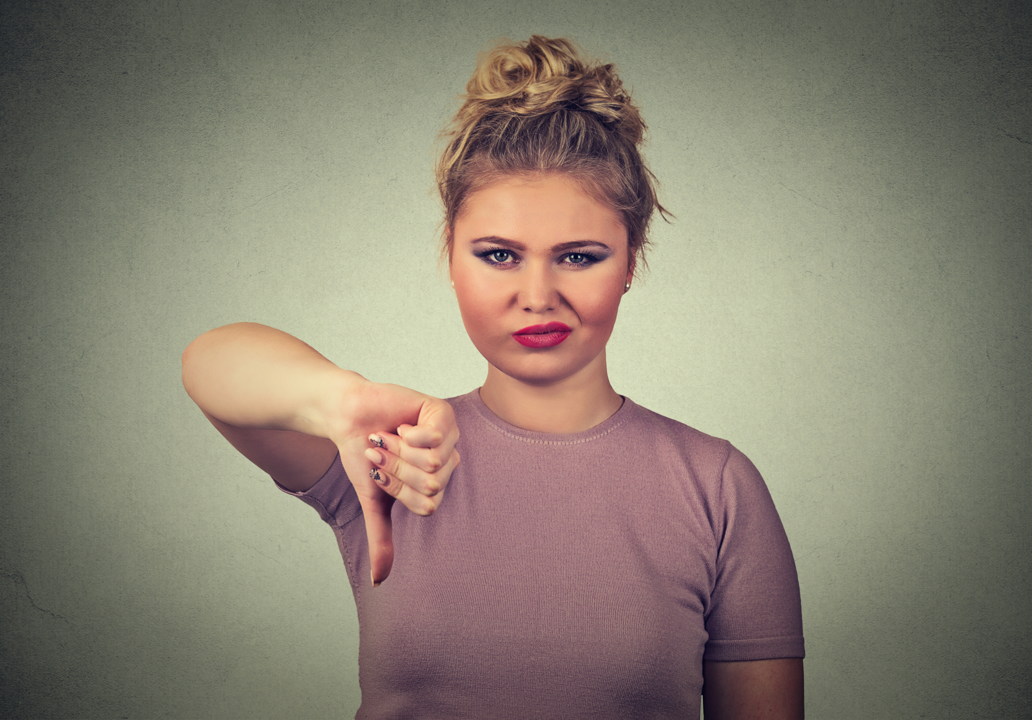 Woman giving a thumbs down sign