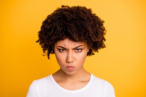A woman frowning.