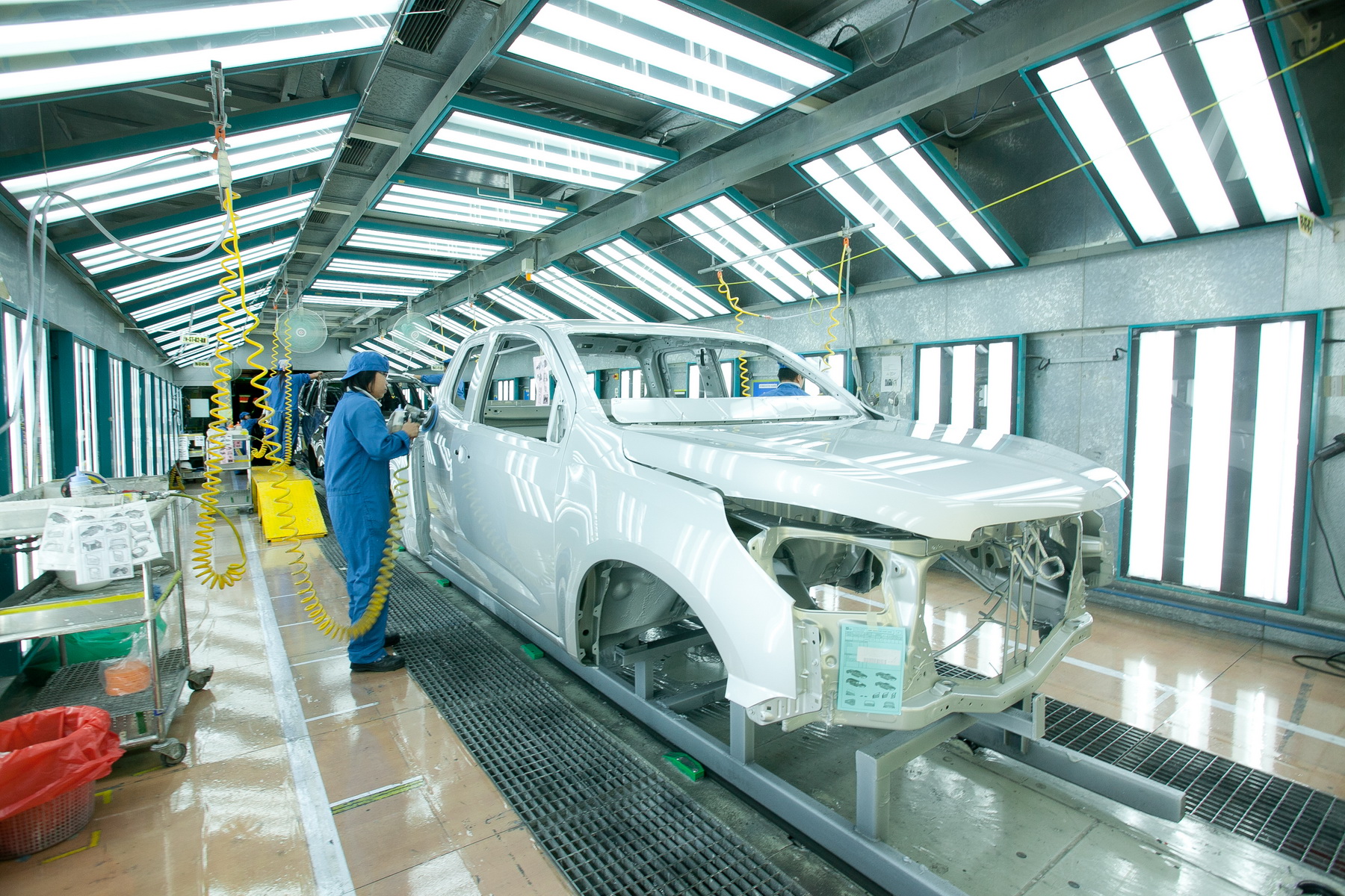 A worker attends to a partially assembled truck on the assembly line at GM's Rayong, Thailand, factory.