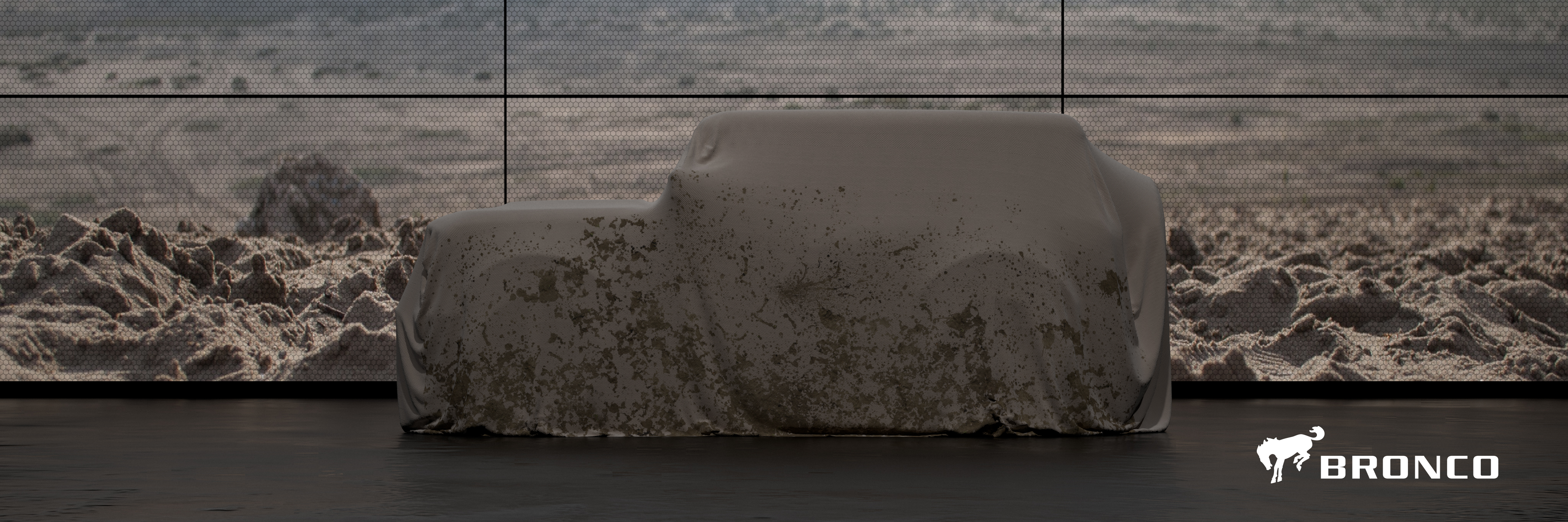 A prototype Ford Bronco, under a fabric cover.
