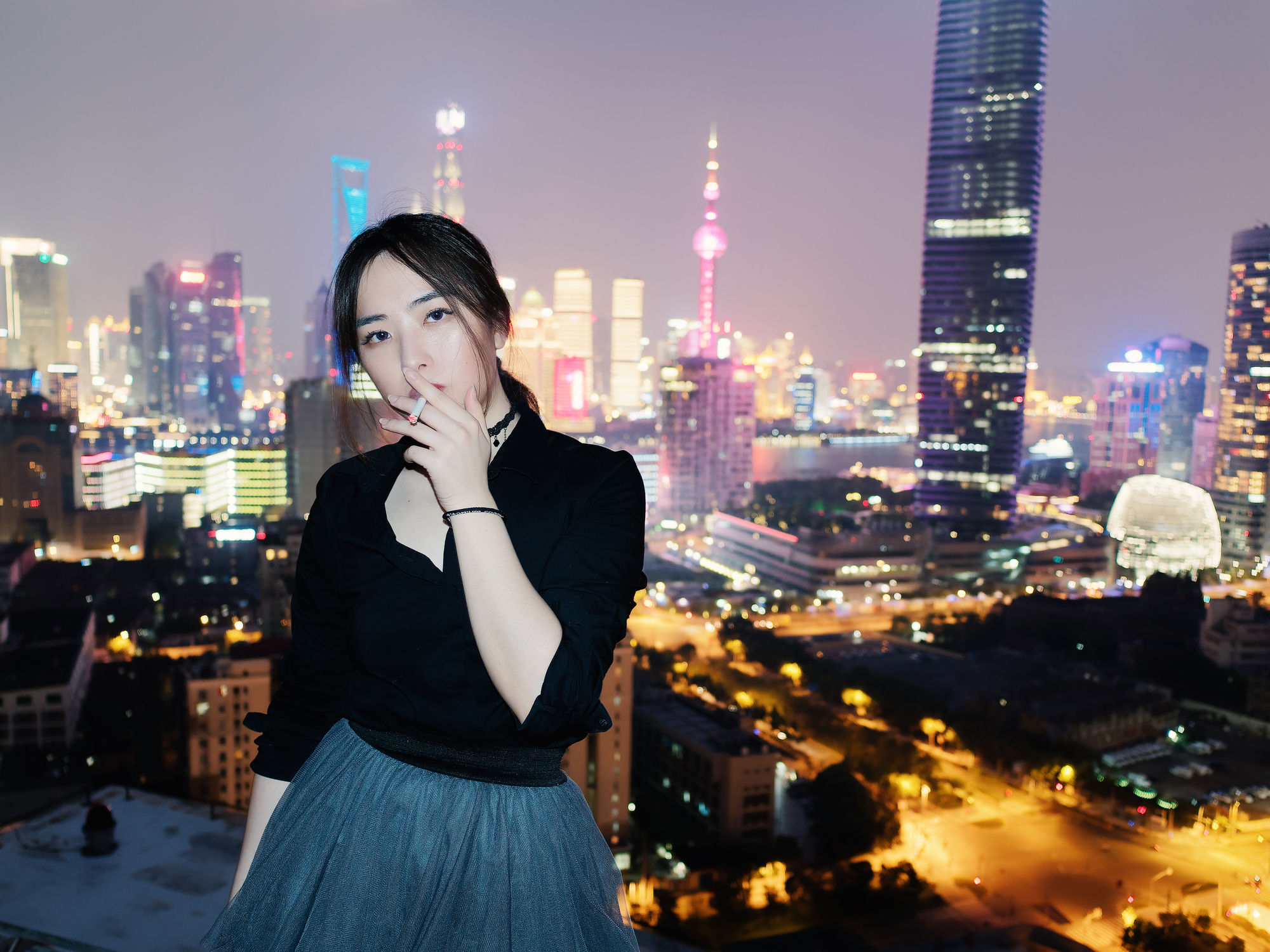 A young woman smokes a cigarette in Shanghai.