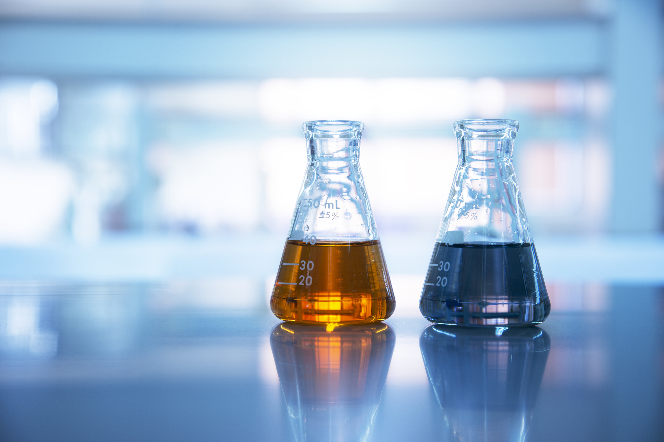 Two flasks full of different colored chemicals