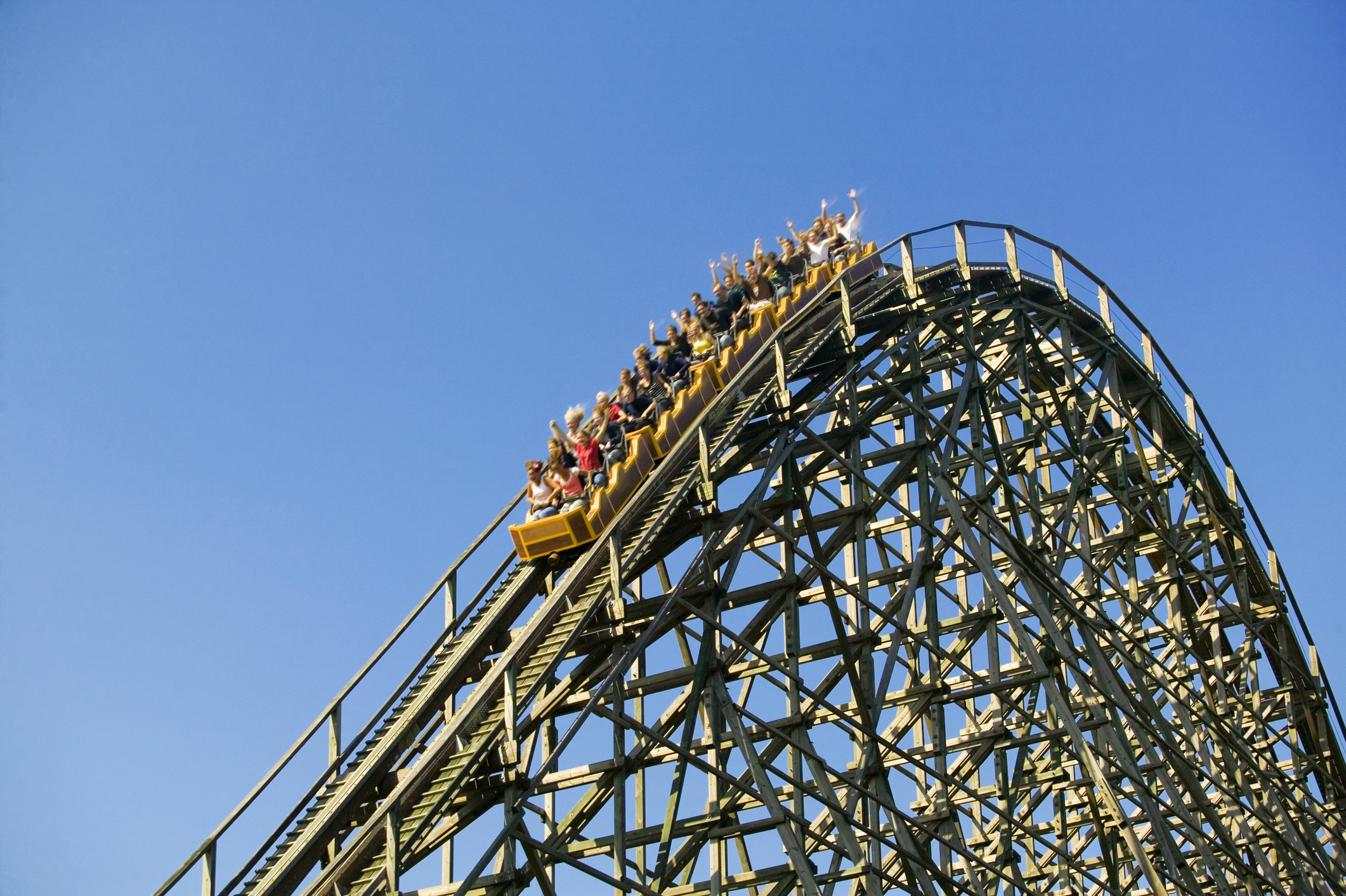 Riders on a roller coaster.