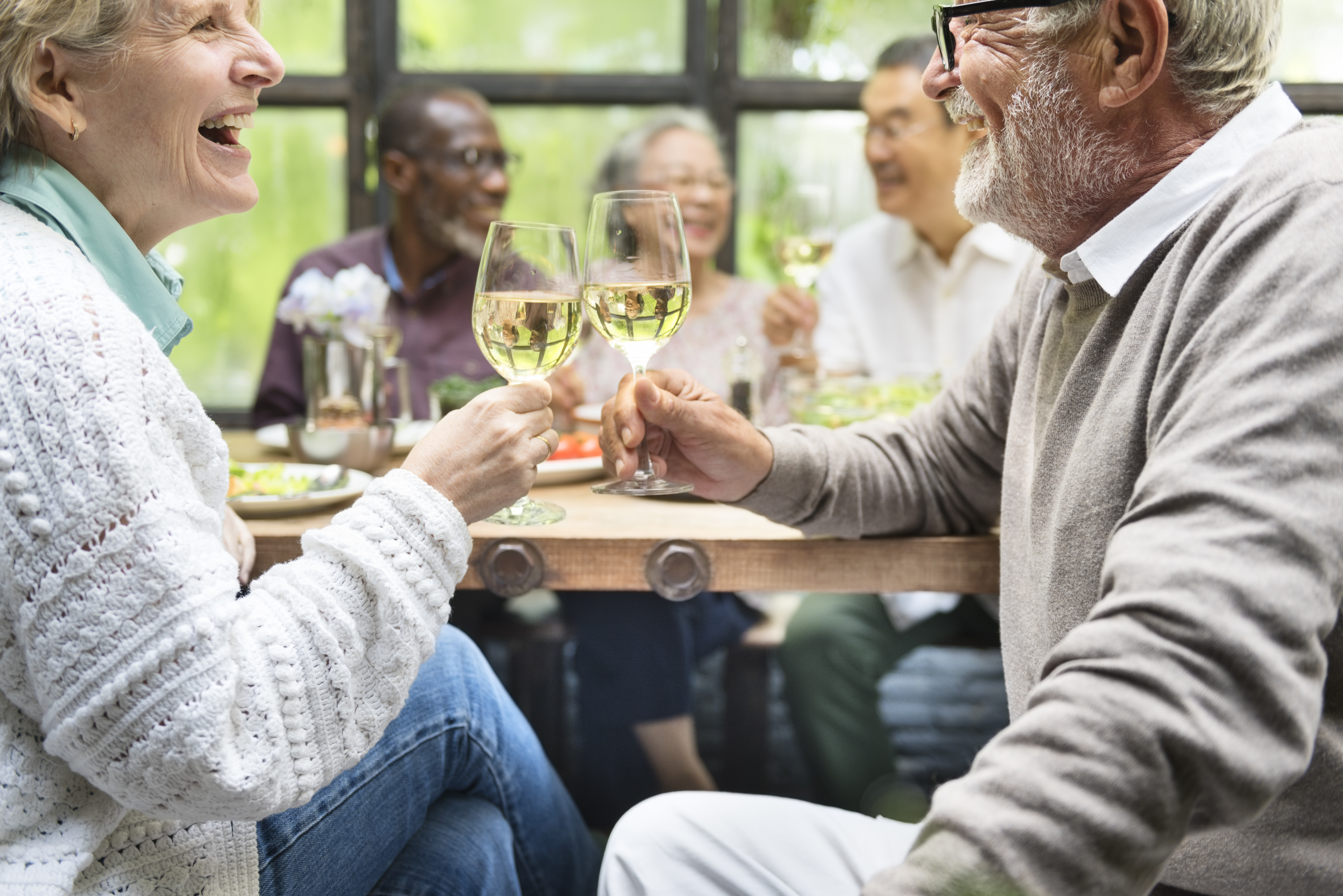 Senior couple toasting with champagne at a party