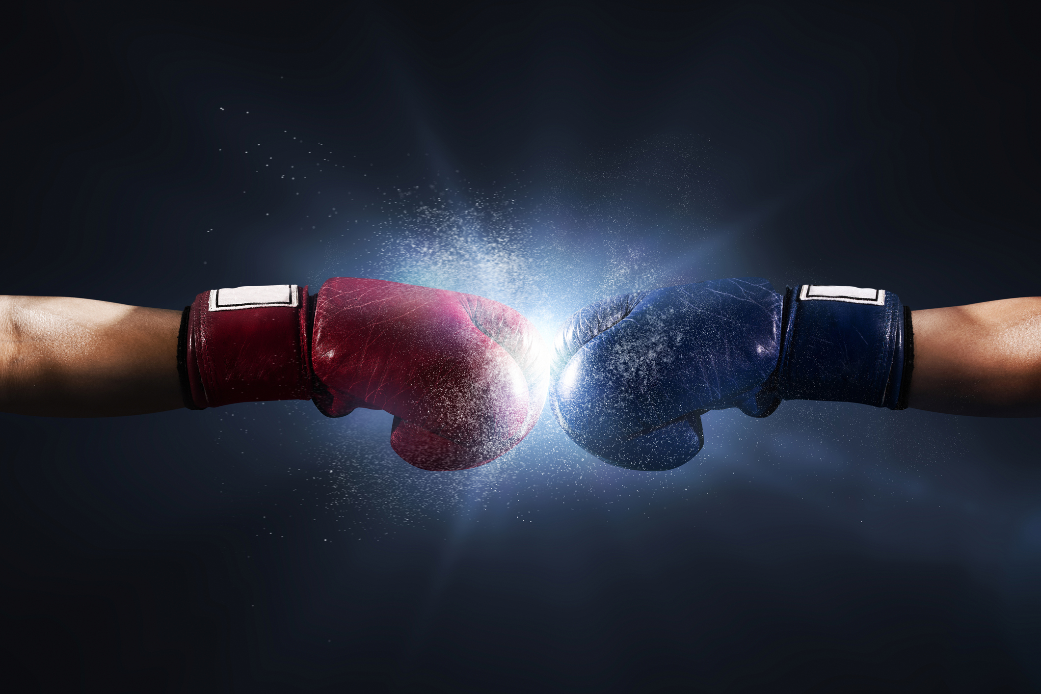 Two boxers with straight arms touch their gloves together.
