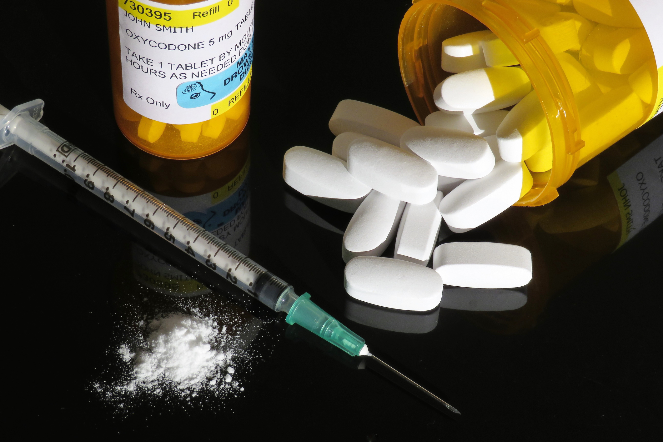 Opioid pills and syringe.