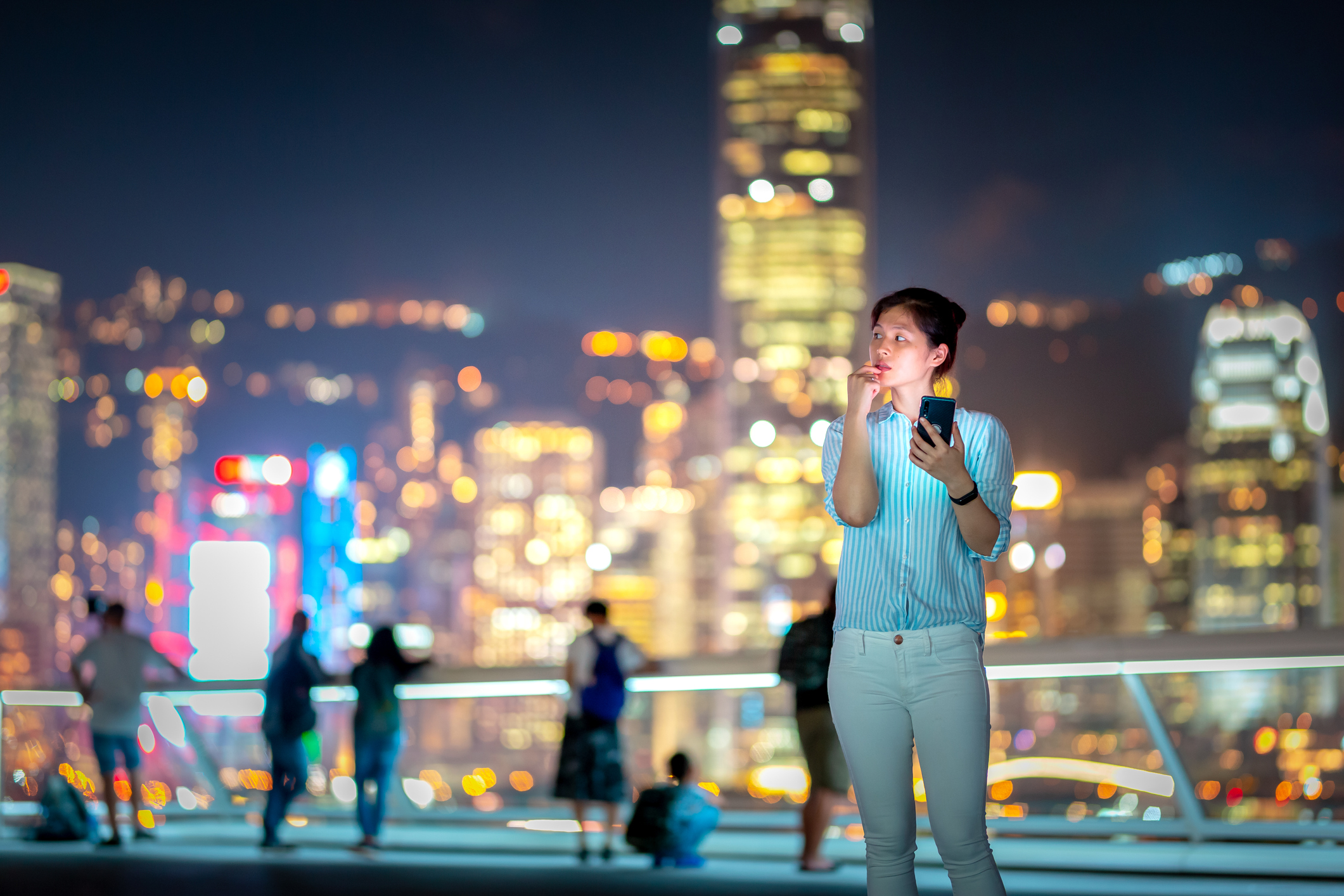 A young woman uses a smartphone.