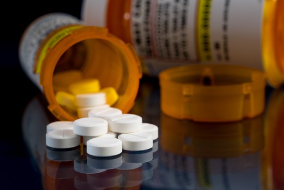Pills spilling out of a medication bottle