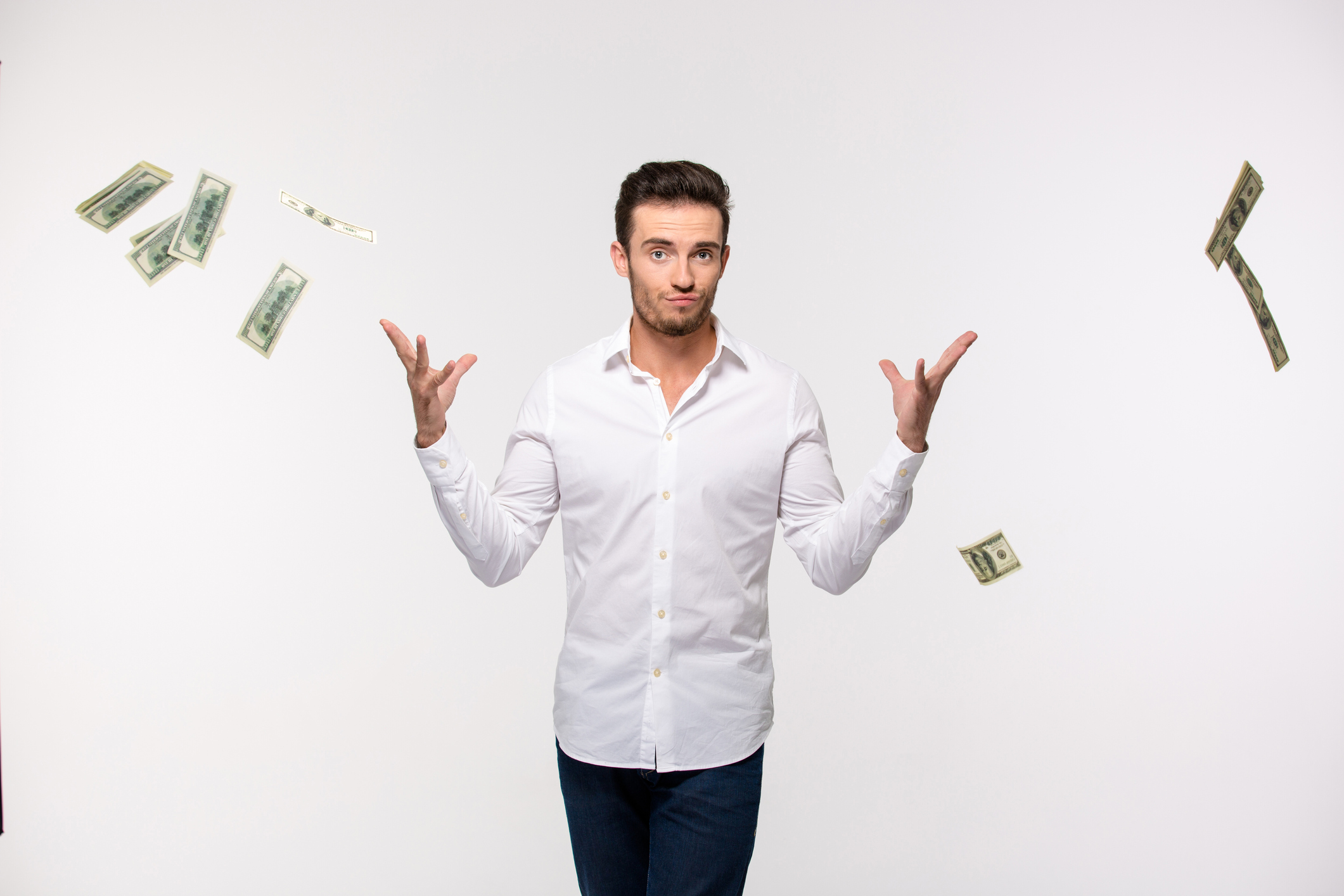 Man throwing bills into the air