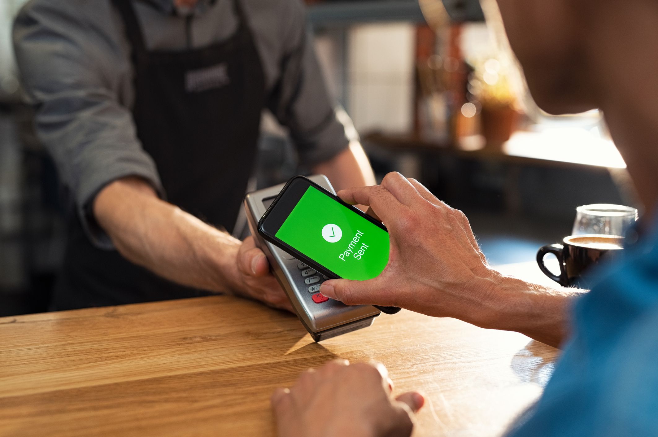 A customer pays for a coffee with a mobile app.